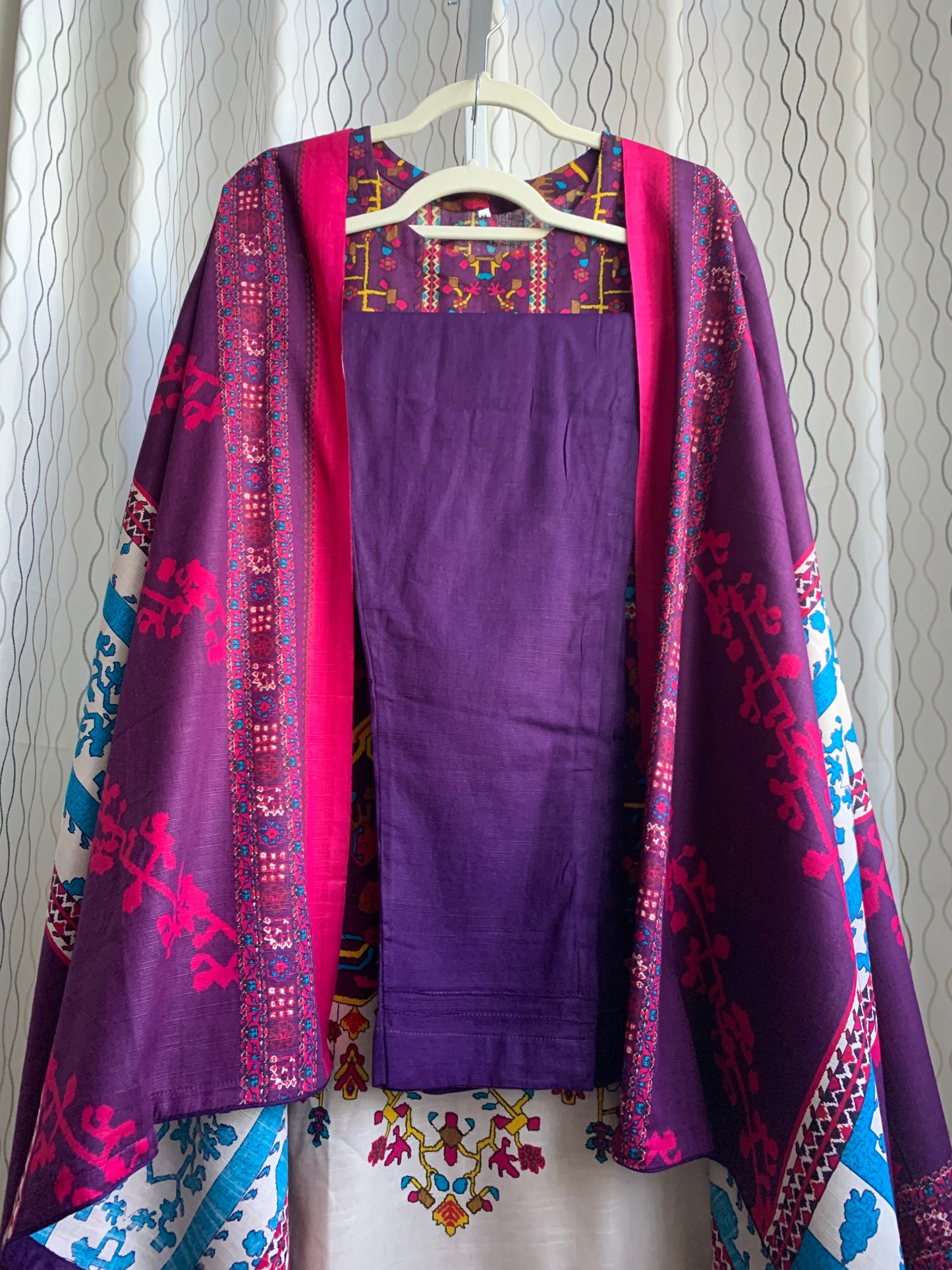 Modest Khaddar Suit for Women: it offers a Modest Style and Custom Stitch. Crafted with Exotic Khaddar Fabric, which is a blend of Organic Cotton and Wool Slub. This 3 piece suit includes one Tunic, matching Trouser and a full Shawl, perfect for the winter season. Available in Plum (Dark Purple) color and S-M-L-XL sizes, and guarantees both comfort and elegance.