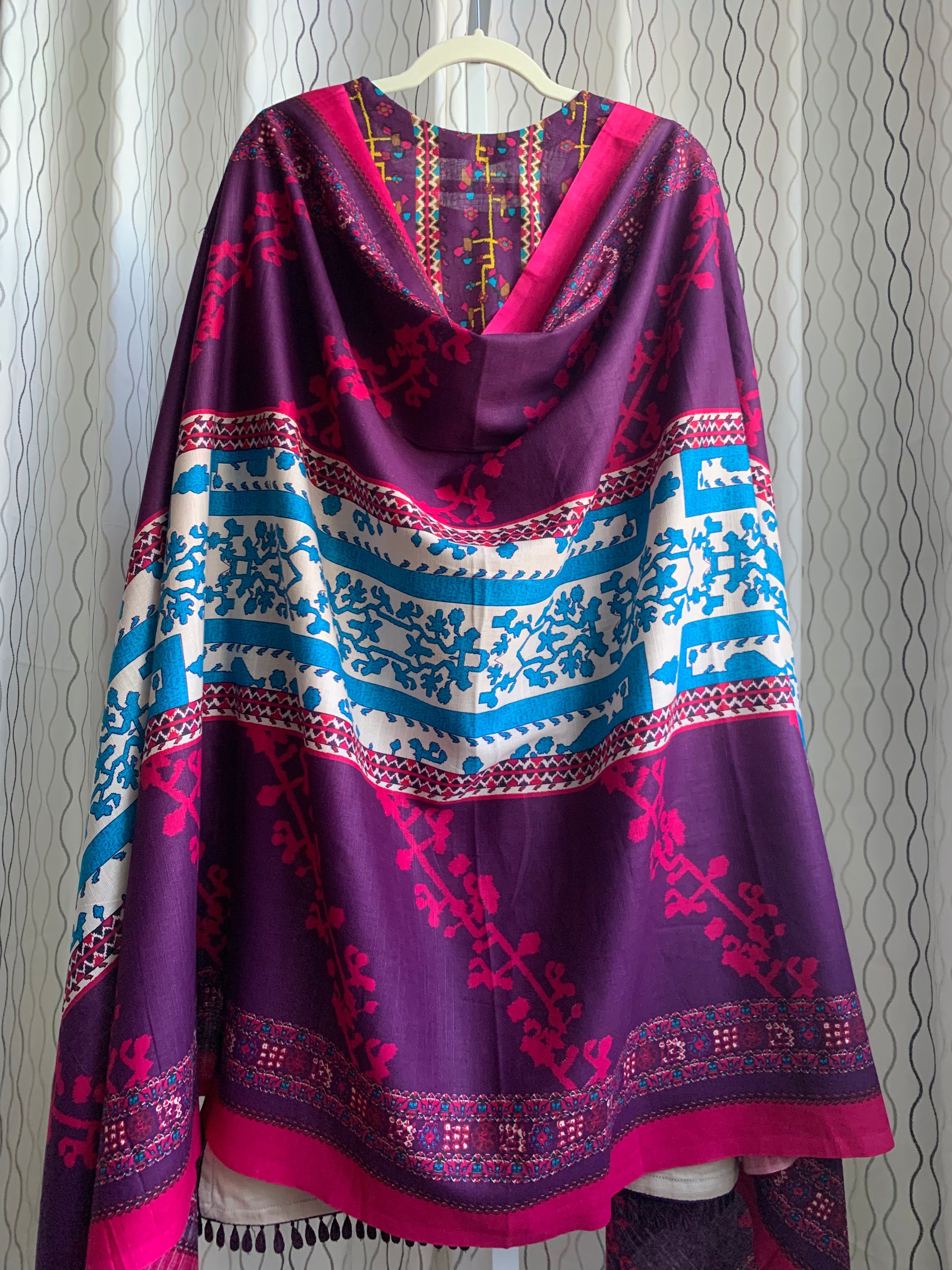 Modest Khaddar Suit for Women:  it offers a Modest Style along with Custom Stitch. Crafted with Exotic Khaddar Fabric, which is a blend of Organic Cotton and Wool Slub. This 3 piece suit includes one Tunic, matching Trouser and a full Shawl, perfect for the winter season. Available in Plum (Dark Purple) color and S-M-L-XL  sizes, and guarantees both comfort and elegance.