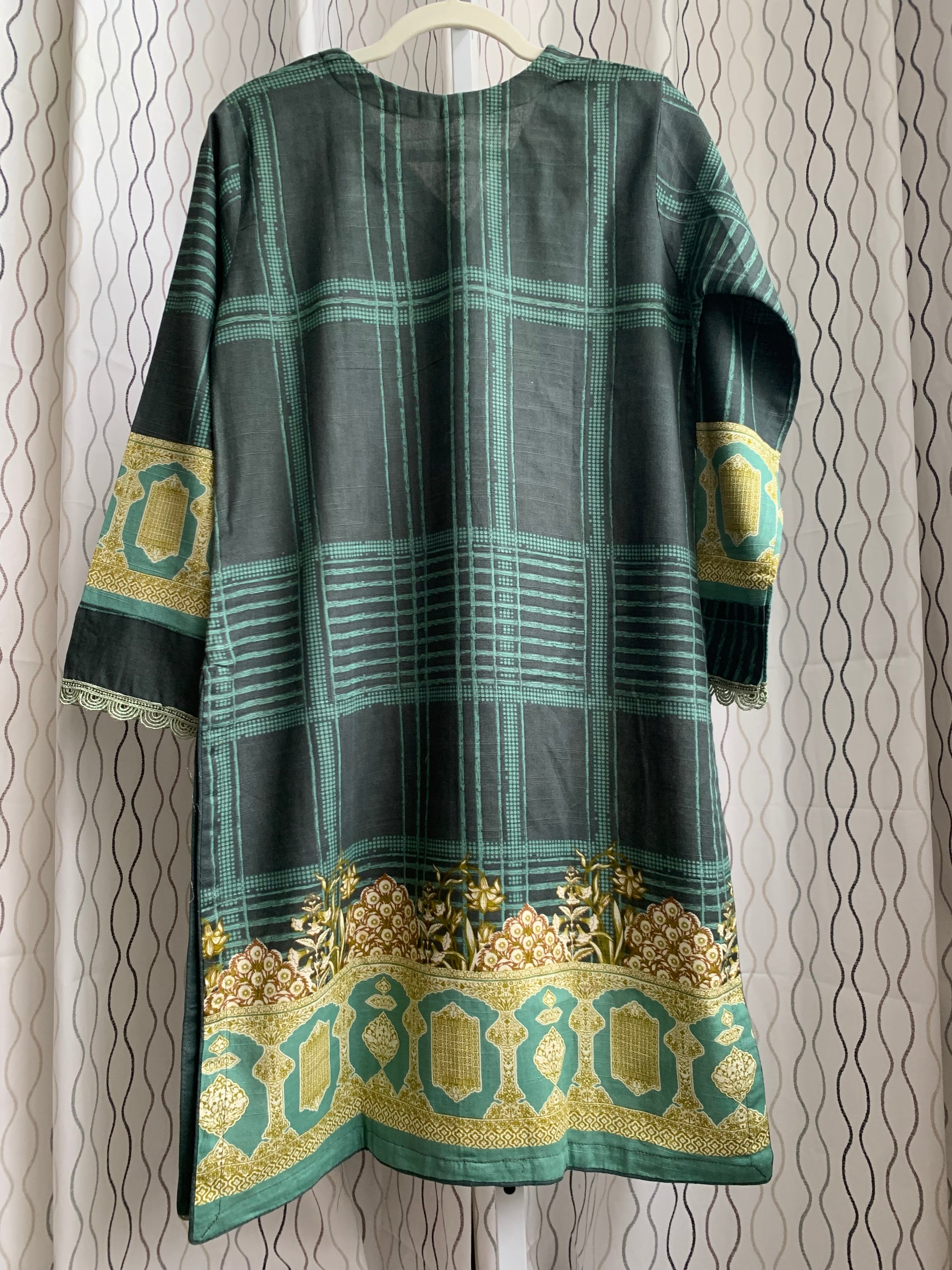 Modest Khaddar Suit for Women:  it offers a Modest Style and Custom Stitch. Crafted with Exotic Khaddar Fabric, which is a blend of Organic Cotton and Wool Slub. This 3 piece suit includes one Tunic, matching Trouser and a full Shawl, perfect for the winter season. Available in Green color and S-M-L-XL  sizes, and guarantees both comfort and elegance.