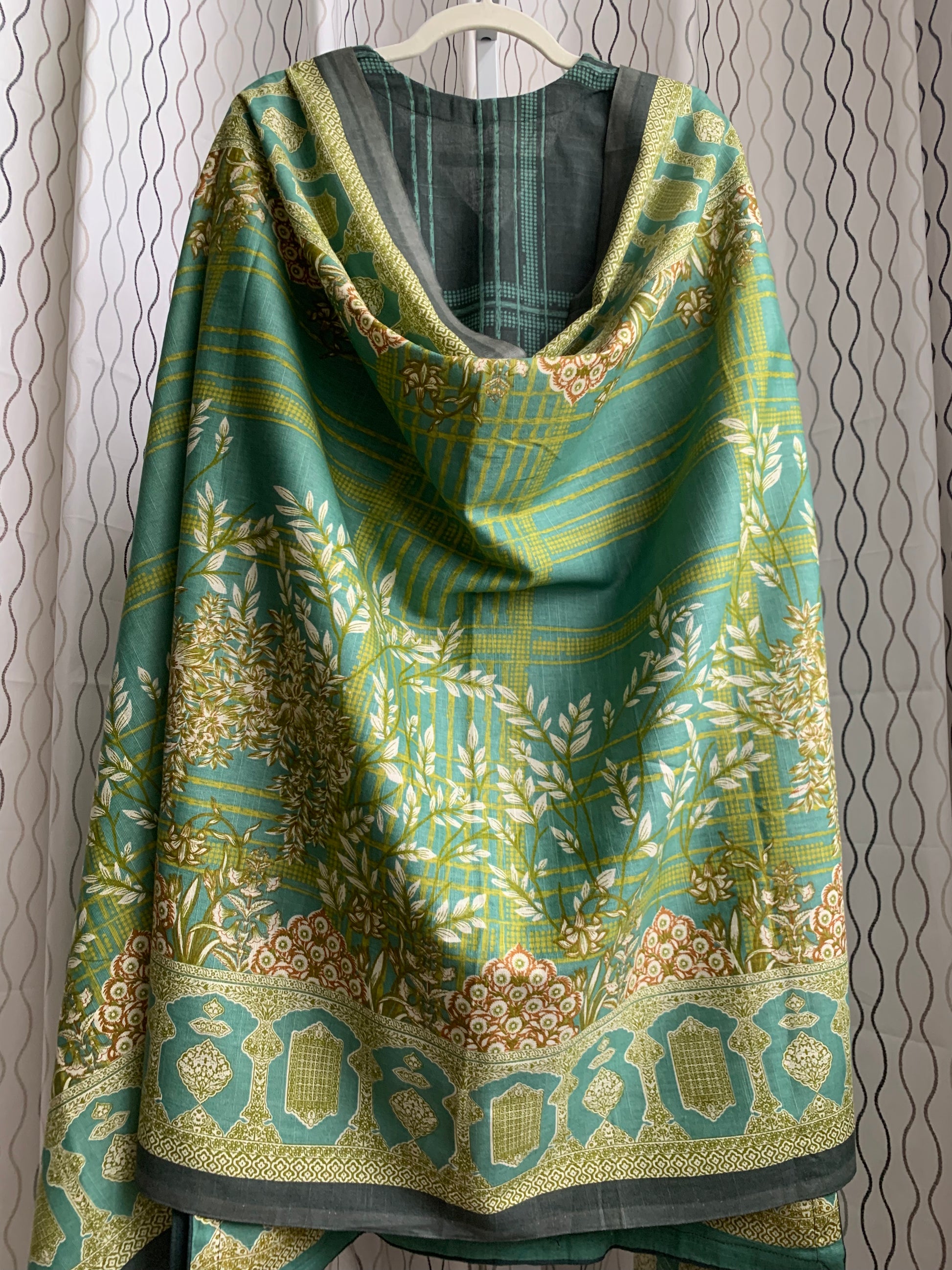 Modest Khaddar Suit for Women:  it offers a Modest Style and Custom Stitch. Crafted with Exotic Khaddar Fabric, which is a blend of Organic Cotton and Wool Slub. This 3 piece suit includes one Tunic, matching Trouser and a full Shawl, perfect for the winter season. Available in Green color and S-M-L-XL  sizes, and guarantees both comfort and elegance.