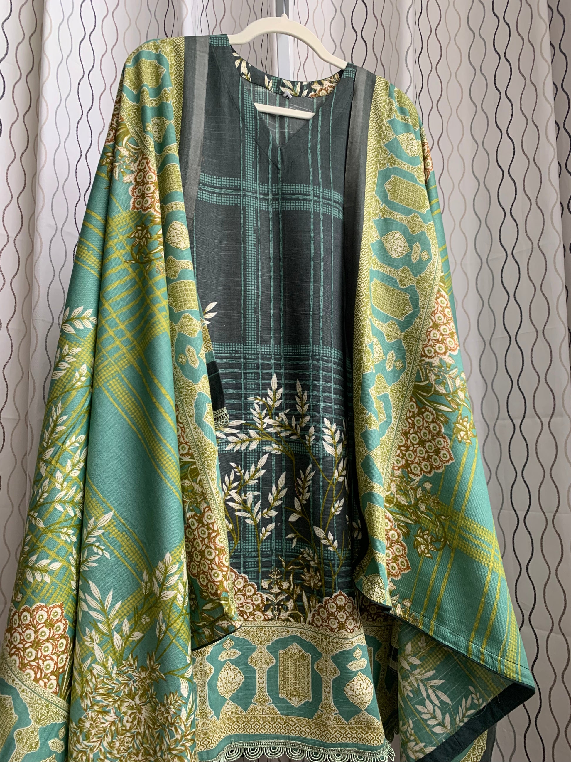 Modest Khaddar Suit for Women:  it offers a Modest Style and Custom Stitch. Crafted with Exotic Khaddar Fabric, which is a blend of Organic Cotton and Wool Slub. This 3 piece suit includes one Tunic, matching Trouser and a full Shawl, perfect for the winter season. Available in Green color and S-M-L-XL  sizes, and guarantees both comfort and elegance.