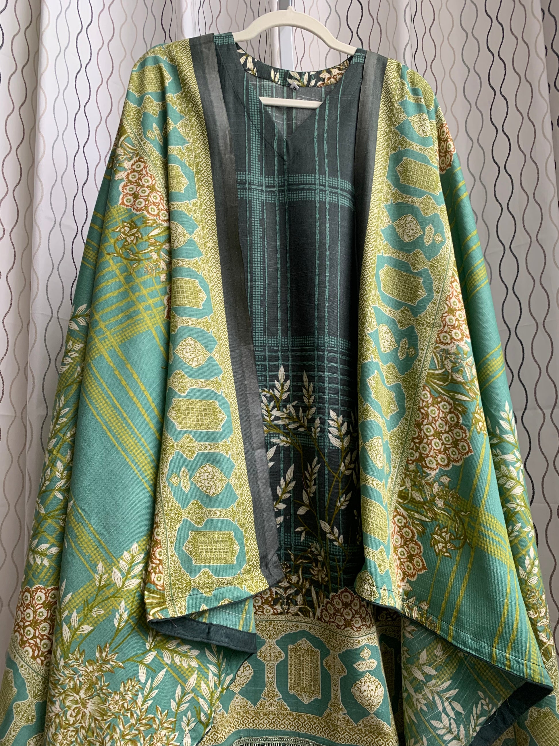 Modest Khaddar Suit for Women:  it offers a Modest Style and Custom Stitch. Crafted with Exotic Khaddar Fabric, which is a blend of Organic Cotton and Wool Slub. This 3 piece suit includes one Tunic, matching Trouser and a full Shawl, perfect for the winter season. Available in Green color and S-M-L-XL  sizes, and guarantees both comfort and elegance.