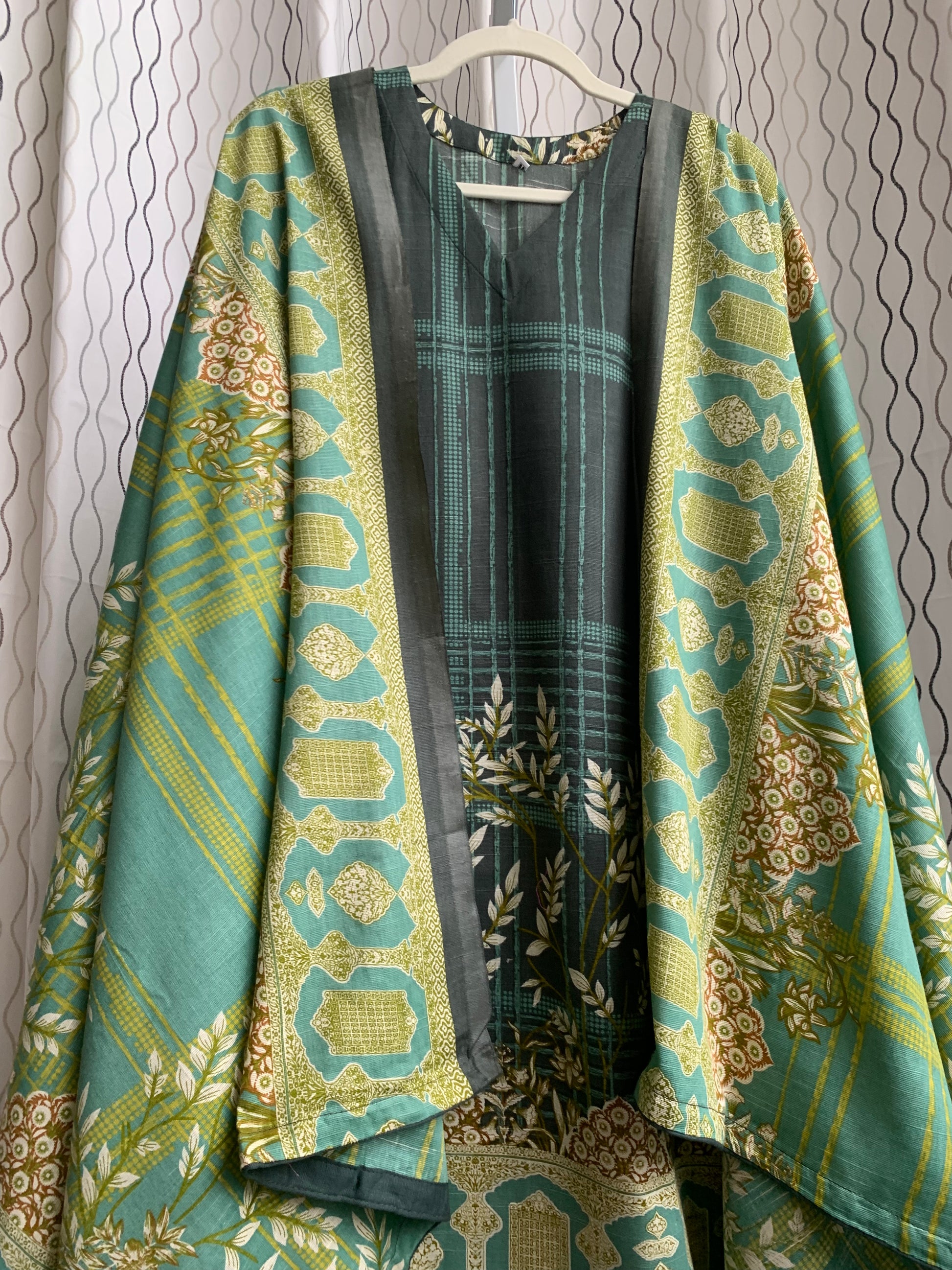 Modest Khaddar Suit for Women:  it offers a Modest Style and Custom Stitch. Crafted with Exotic Khaddar Fabric, which is a blend of Organic Cotton and Wool Slub. This 3 piece suit includes one Tunic, matching Trouser and a full Shawl, perfect for the winter season. Available in Green color and S-M-L-XL  sizes, and guarantees both comfort and elegance.