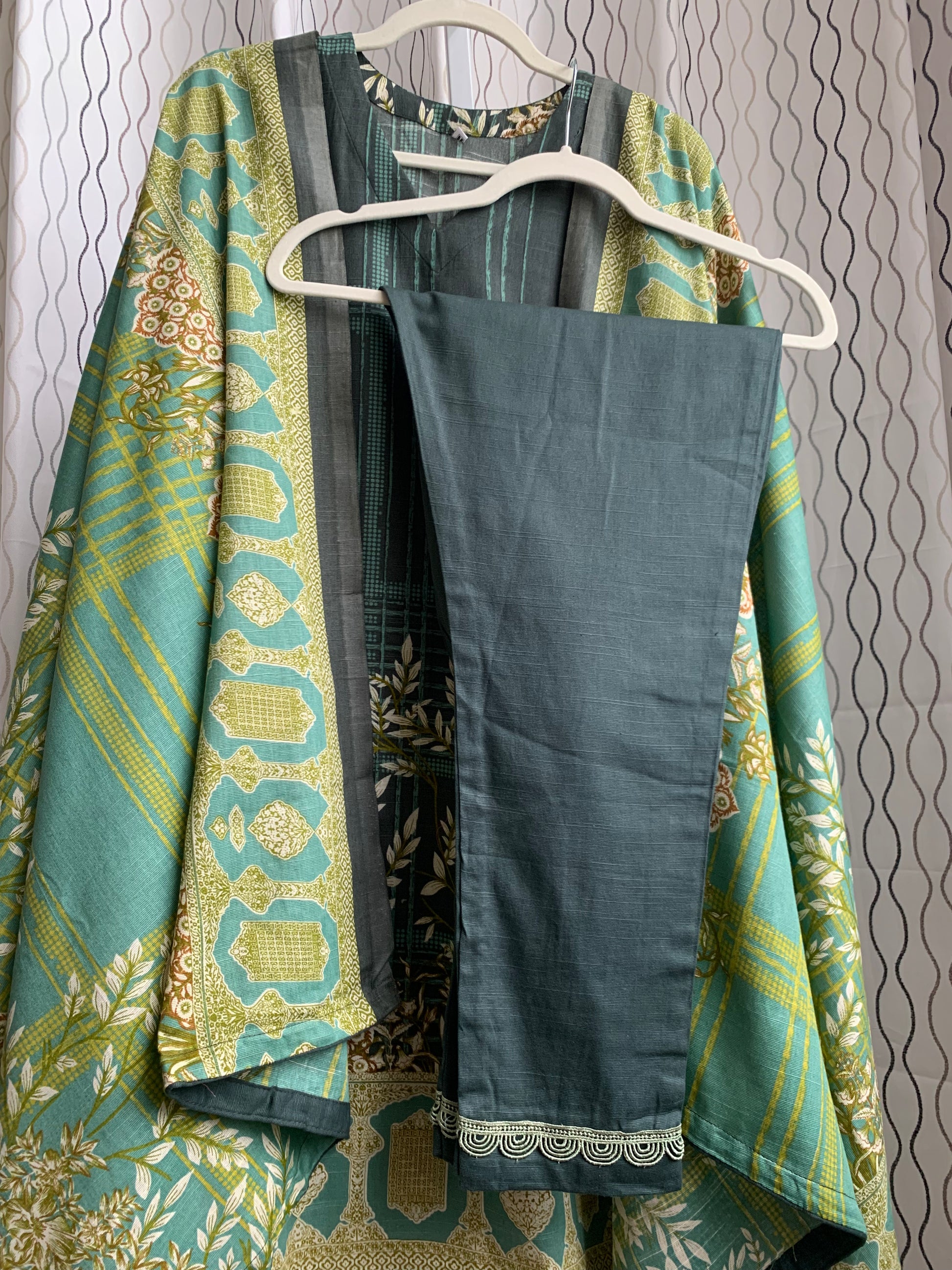 Modest Khaddar Suit for Women:  it offers a Modest Style and Custom Stitch. Crafted with Exotic Khaddar Fabric, which is a blend of Organic Cotton and Wool Slub. This 3 piece suit includes one Tunic, matching Trouser and a full Shawl, perfect for the winter season. Available in Green color and S-M-L-XL  sizes, and guarantees both comfort and elegance.