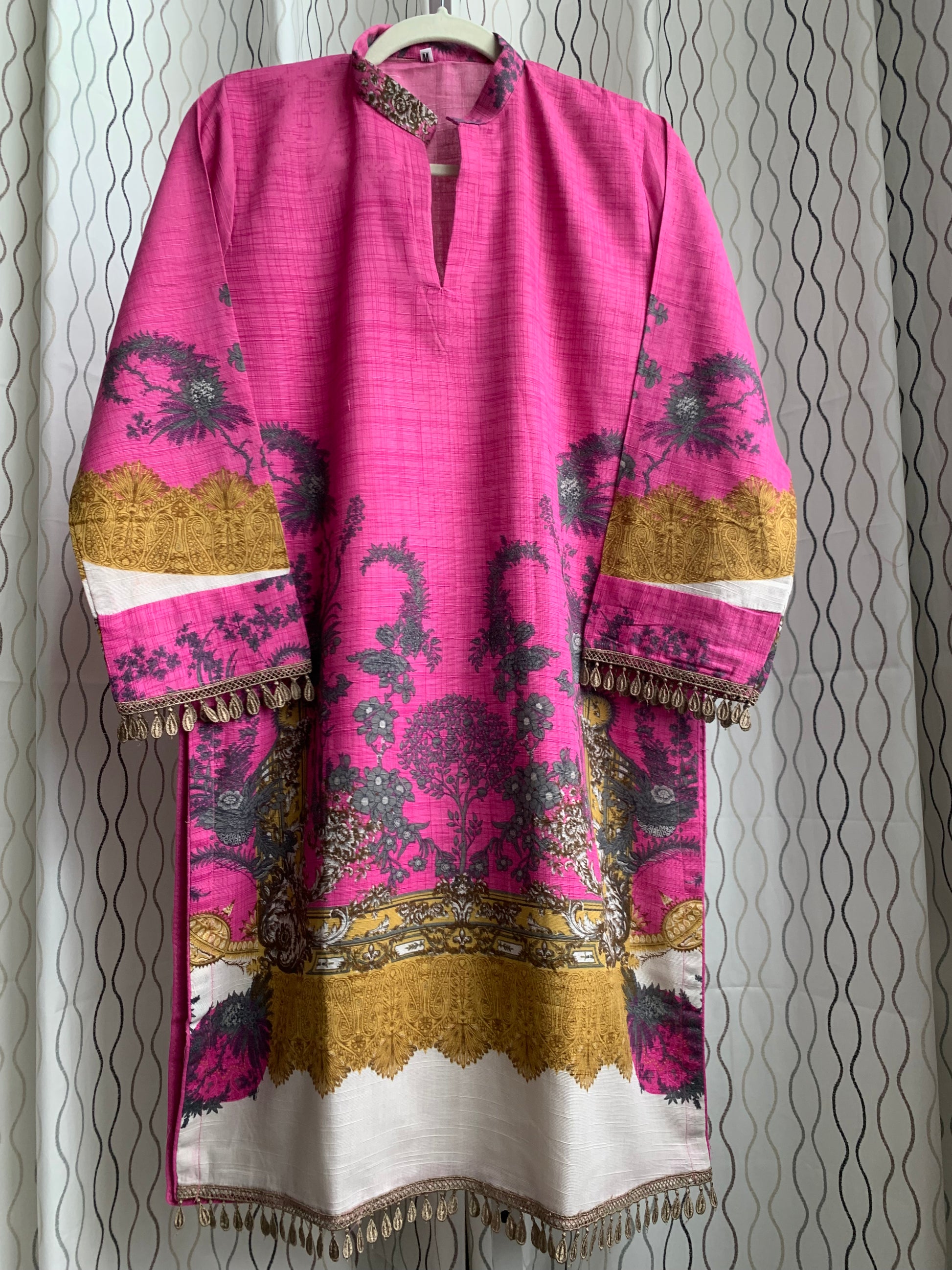 Modest Khaddar Suit for Women:  it offers a Modest Style and Custom Stitch. Crafted with Exotic Khaddar Fabric, which is a blend of Organic Cotton and Wool Slub. This 3 piece suit includes one Tunic, matching Trouser and a full Shawl, perfect for the winter season. Available in Pink color and S-M-L-XL  sizes, and guarantees both comfort and elegance.