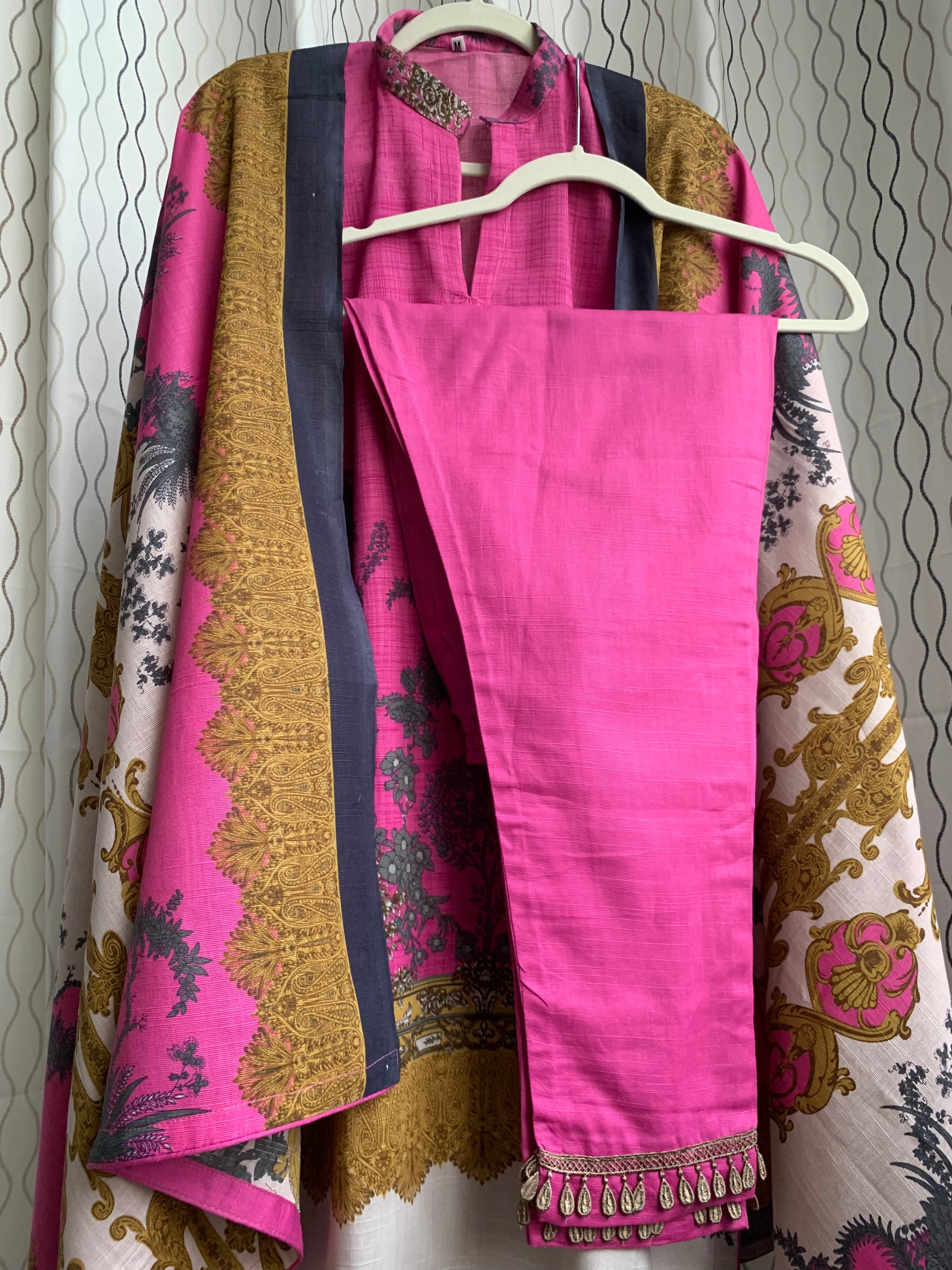 Modest Khaddar Suit for Women:  it offers a Modest Style and Custom Stitch. Crafted with Exotic Khaddar Fabric, which is a blend of Organic Cotton and Wool Slub. This 3 piece suit includes one Tunic, matching Trouser and a full Shawl, perfect for the winter season. Available in Pink color and S-M-L-XL  sizes, and guarantees both comfort and elegance.