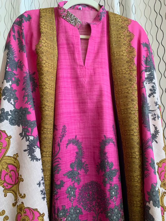 Modest Khaddar Suit for Women:  it offers a Modest Style and Custom Stitch. Crafted with Exotic Khaddar Fabric, which is a blend of Organic Cotton and Wool Slub. This 3 piece suit includes one Tunic, matching Trouser and a full Shawl, perfect for the winter season. Available in Pink color and S-M-L-XL  sizes, and guarantees both comfort and elegance.