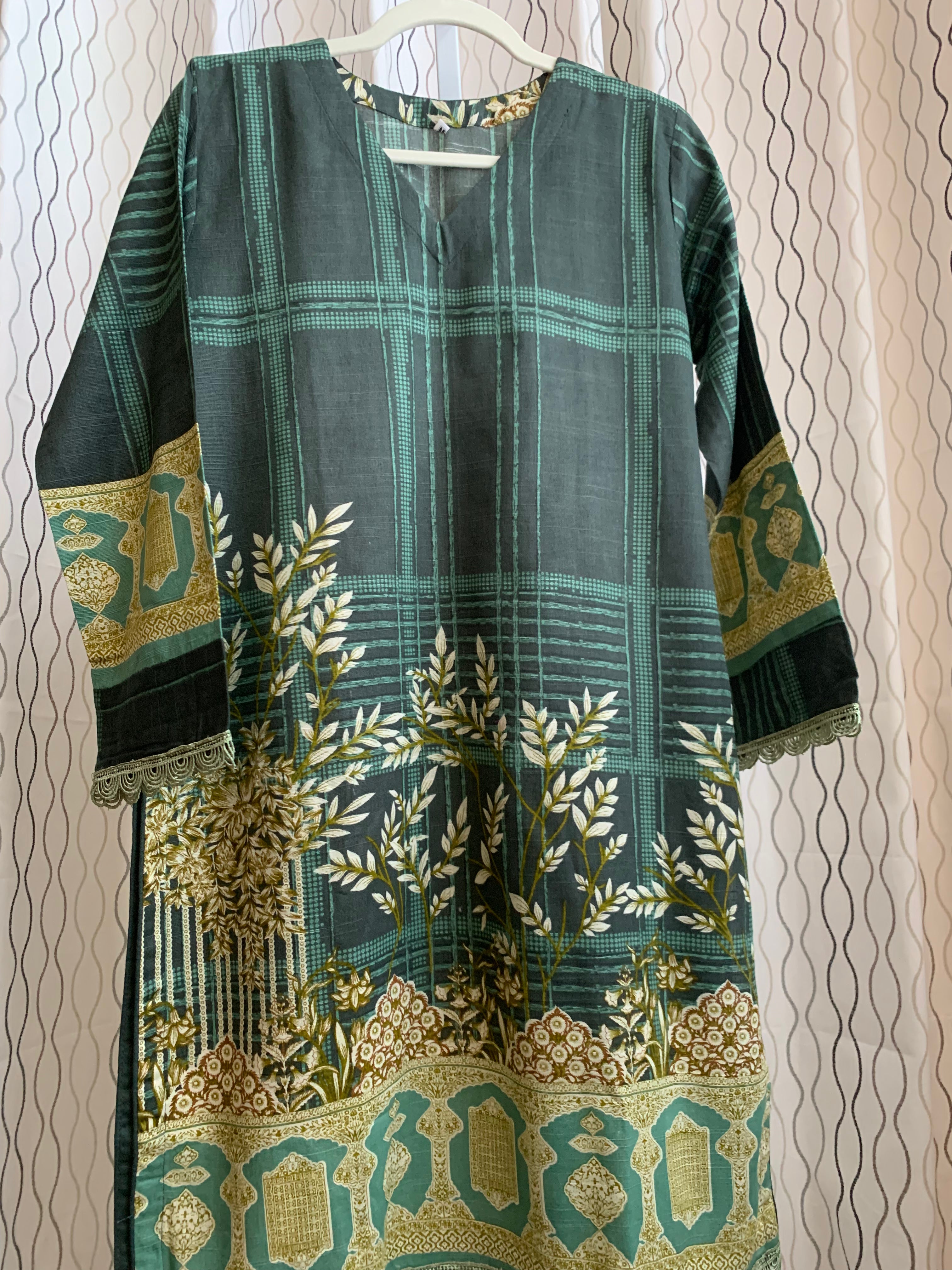 Modest Khaddar Suit for Women:  it offers a Modest Style and Custom Stitch. Crafted with Exotic Khaddar Fabric, which is a blend of Organic Cotton and Wool Slub. This 3 piece suit includes one Tunic, matching Trouser and a full Shawl, perfect for the winter season. Available in Green color and S-M-L-XL  sizes, and guarantees both comfort and elegance.