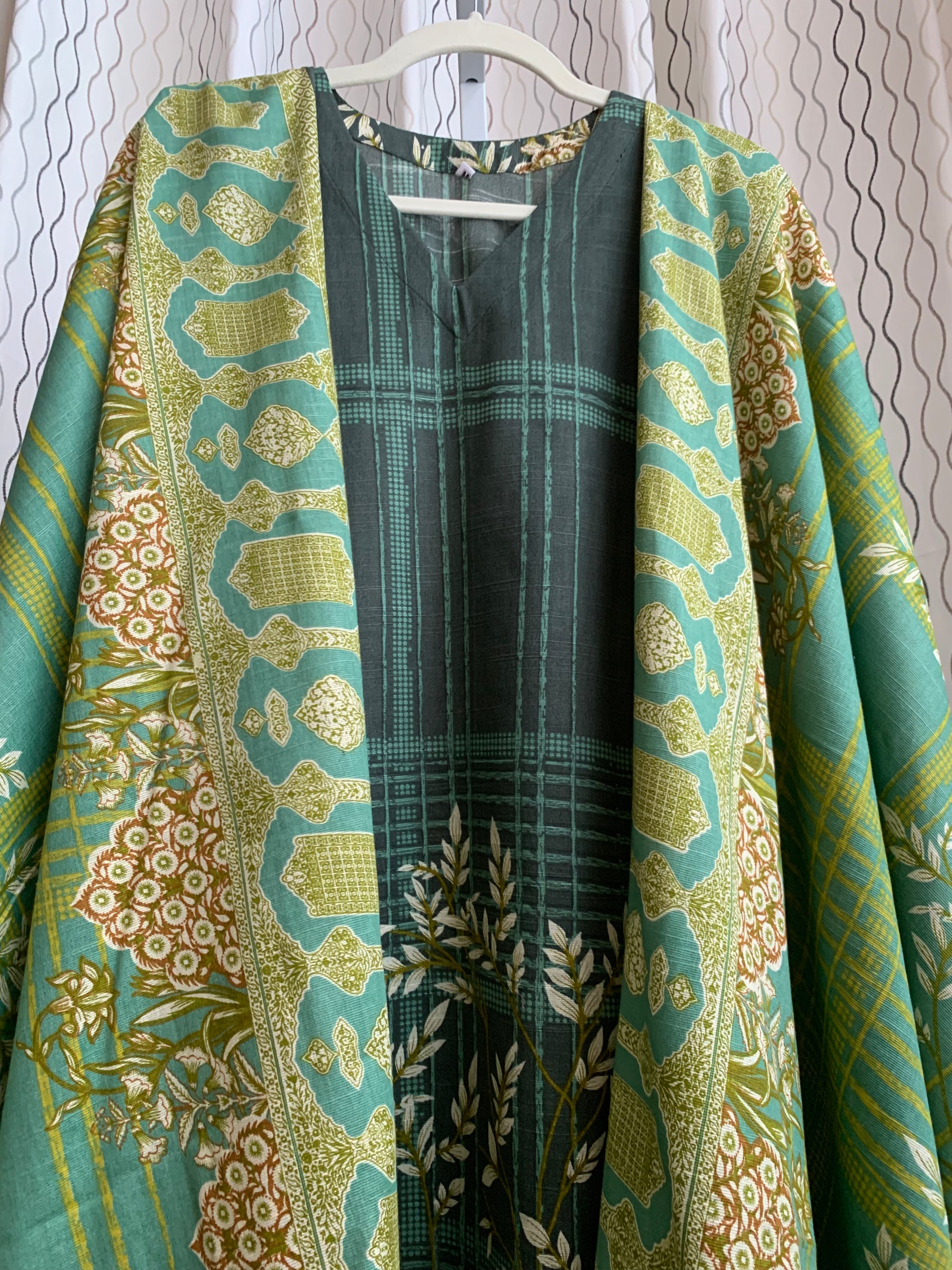 Modest Khaddar Suit for Women:  it offers a Modest Style and Custom Stitch. Crafted with Exotic Khaddar Fabric, which is a blend of Organic Cotton and Wool Slub. This 3 piece suit includes one Tunic, matching Trouser and a full Shawl, perfect for the winter season. Available in Green color and S-M-L-XL  sizes, and guarantees both comfort and elegance.