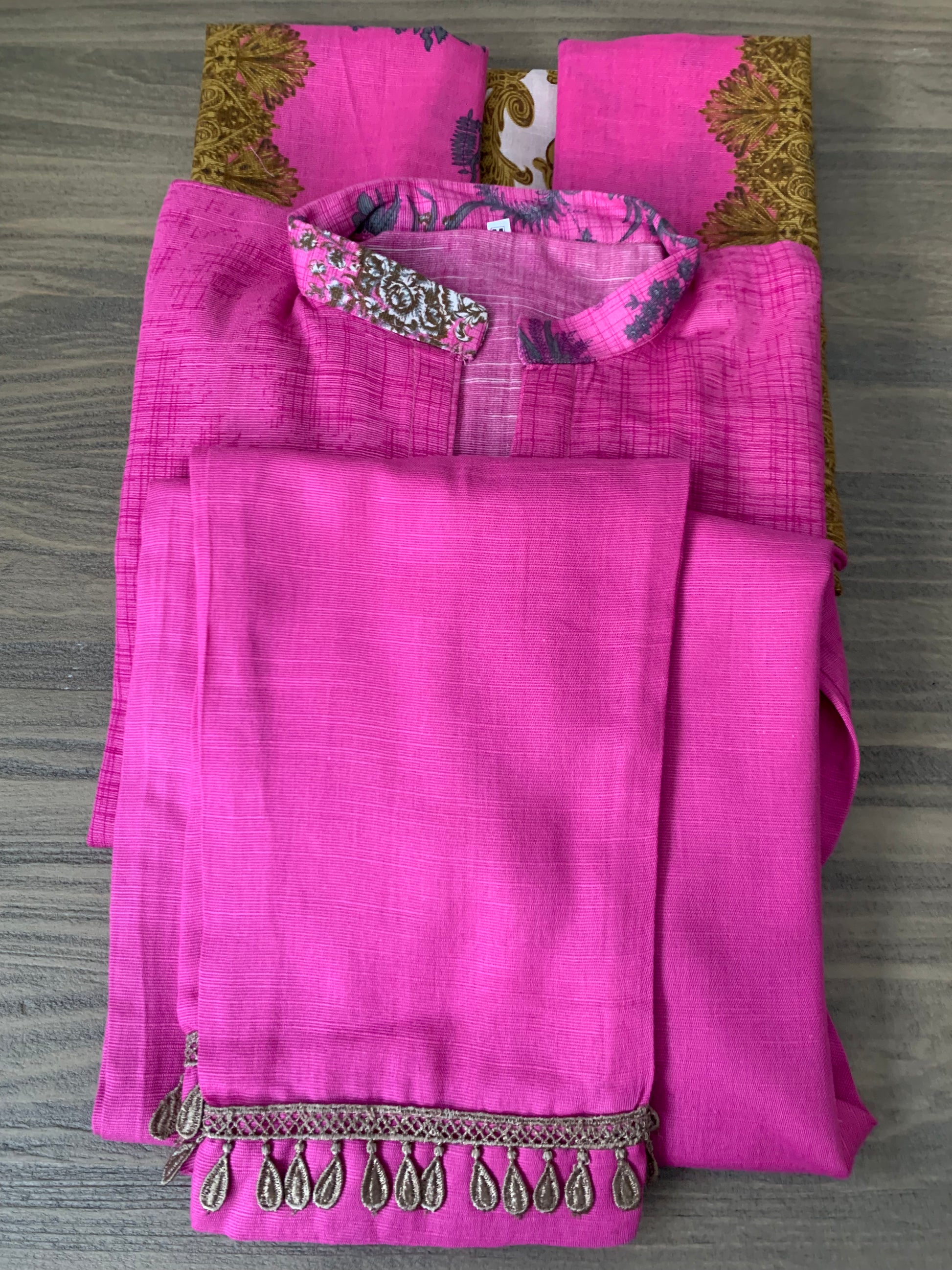 Modest Khaddar Suit for Women:  it offers a Modest Style and Custom Stitch. Crafted with Exotic Khaddar Fabric, which is a blend of Organic Cotton and Wool Slub. This 3 piece suit includes one Tunic, matching Trouser and a full Shawl, perfect for the winter season. Available in Pink color and S-M-L-XL  sizes, and guarantees both comfort and elegance.