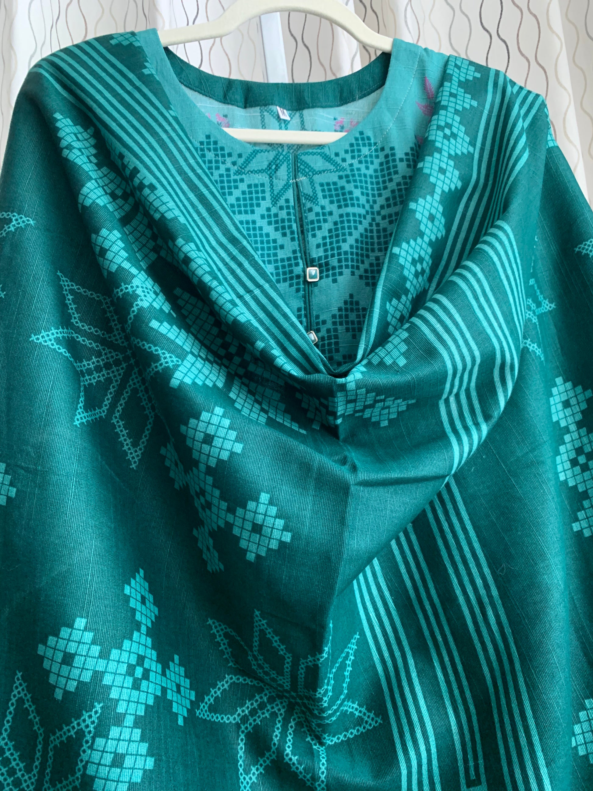 Modest Khaddar Suit for Women:  it offers a Modest Relax Fit Style along with Custom Stitch. Crafted with Exotic Khaddar Fabric, which is a blend of Organic Cotton and Wool Slub. This 3 piece suit includes one Tunic, matching Trouser and a full Shawl, perfect for the winter season. Available in Green color and S-M-L-XL  sizes, and guarantees both comfort and elegance.