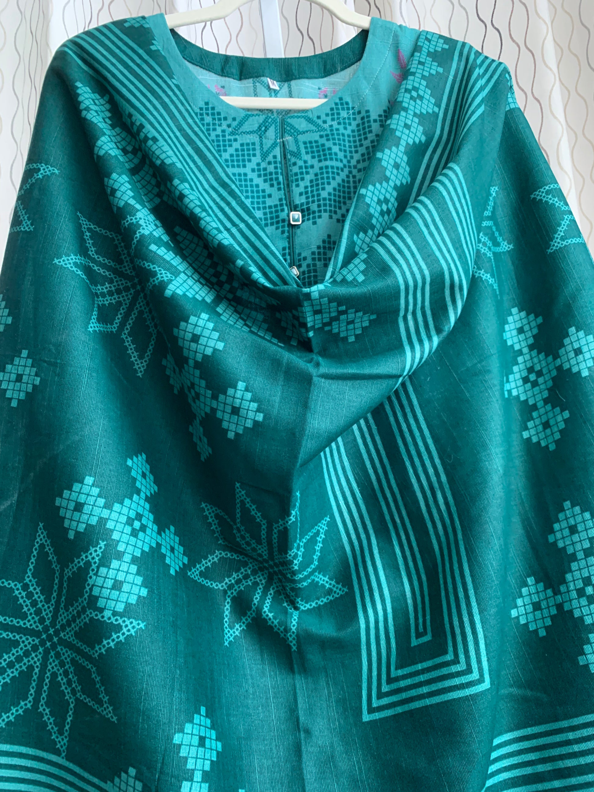 Modest Khaddar Suit for Women:  it offers a Modest Relax Fit Style along with Custom Stitch. Crafted with Exotic Khaddar Fabric, which is a blend of Organic Cotton and Wool Slub. This 3 piece suit includes one Tunic, matching Trouser and a full Shawl, perfect for the winter season. Available in Green color and S-M-L-XL  sizes, and guarantees both comfort and elegance.