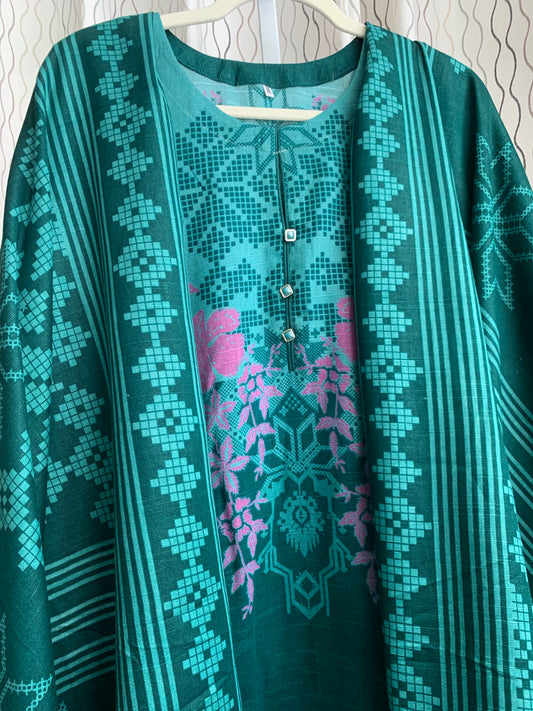 Modest Khaddar Suit for Women:  it offers a Modest Relax Fit Style along with Custom Stitch. Crafted with Exotic Khaddar Fabric, which is a blend of Organic Cotton and Wool Slub. This 3 piece suit includes one Tunic, matching Trouser and a full Shawl, perfect for the winter season. Available in Green color and S-M-L-XL  sizes, and guarantees both comfort and elegance.