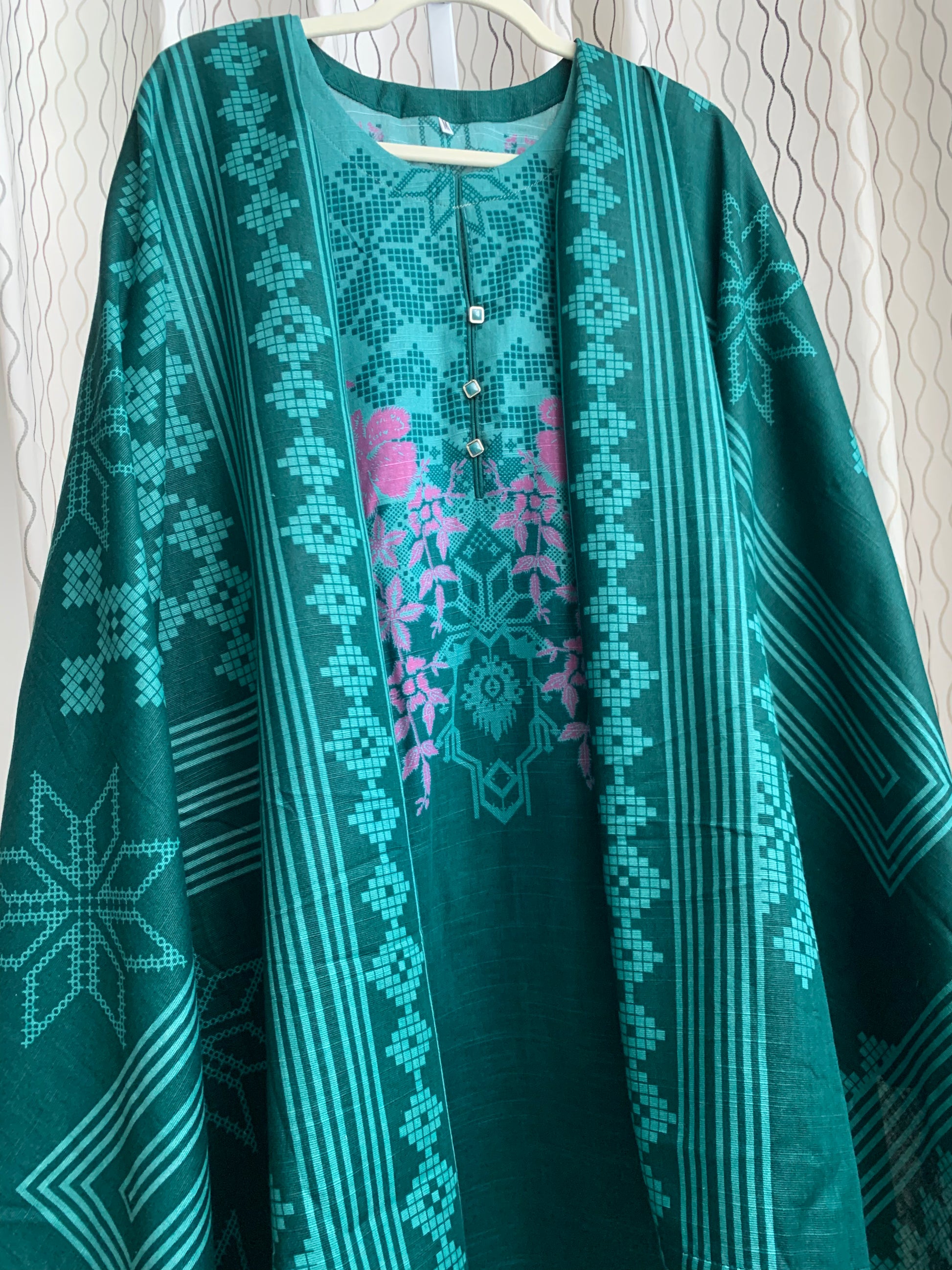 Modest Khaddar Suit for Women:  it offers a Modest Relax Fit Style along with Custom Stitch. Crafted with Exotic Khaddar Fabric, which is a blend of Organic Cotton and Wool Slub. This 3 piece suit includes one Tunic, matching Trouser and a full Shawl, perfect for the winter season. Available in Green color and S-M-L-XL  sizes, and guarantees both comfort and elegance.