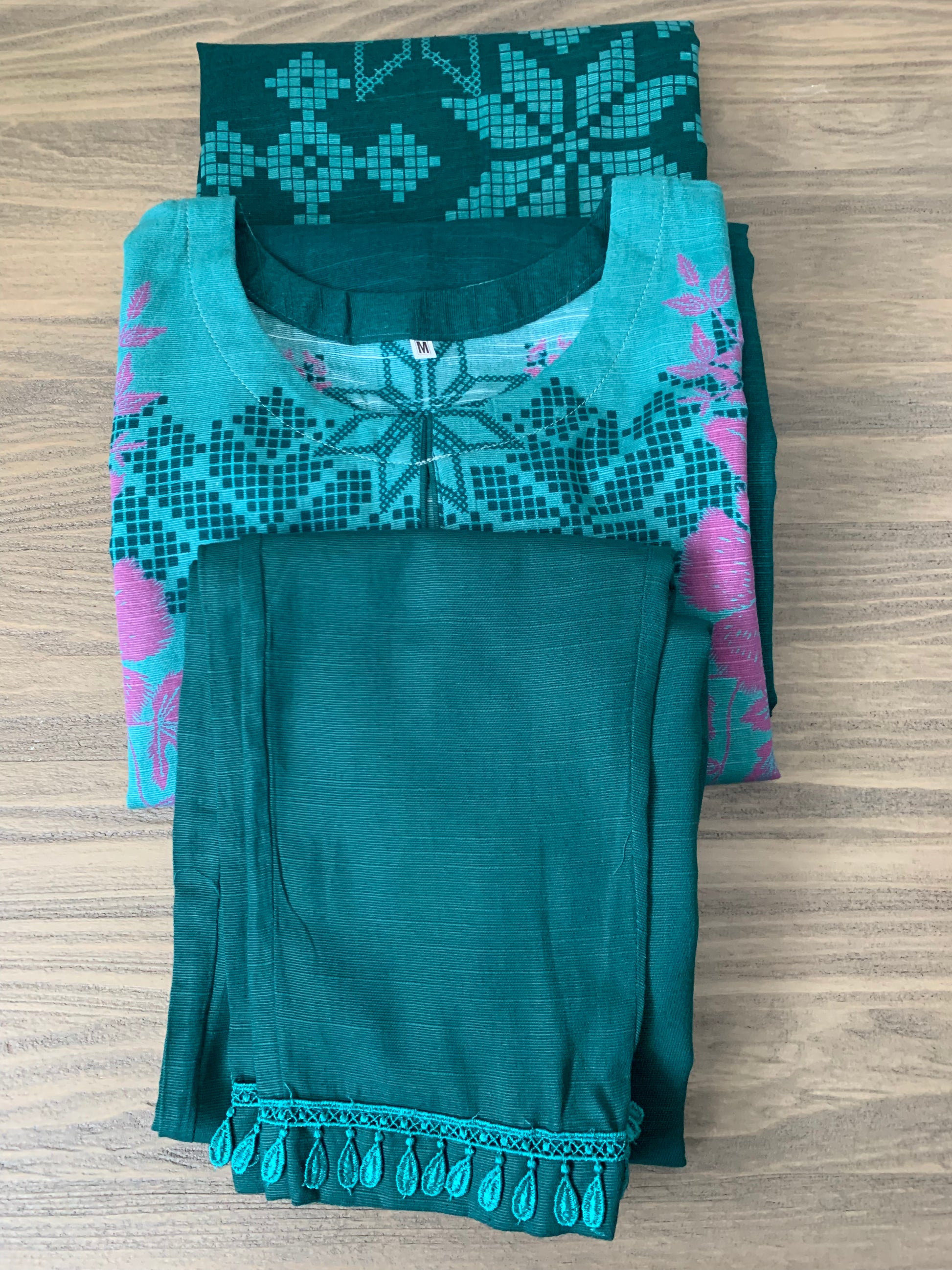 Modest Khaddar Suit for Women:  it offers a Modest Relax Fit Style along with Custom Stitch. Crafted with Exotic Khaddar Fabric, which is a blend of Organic Cotton and Wool Slub. This 3 piece suit includes one Tunic, matching Trouser and a full Shawl, perfect for the winter season. Available in Green color and S-M-L-XL  sizes, and guarantees both comfort and elegance.