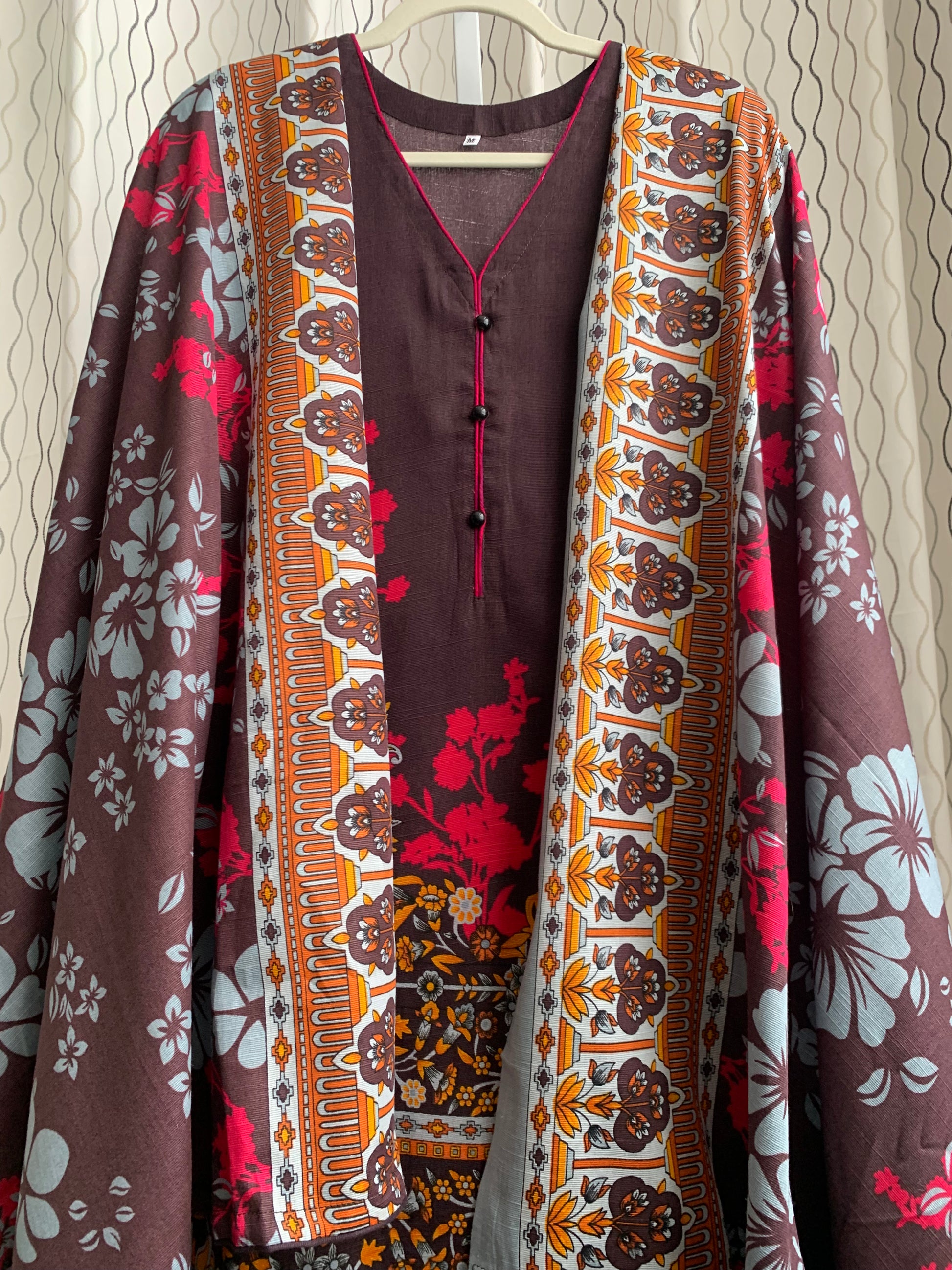 Modest Khaddar Suit for Women:  it offers a Modest Relax Fit Style along with Custom Stitch. Crafted with Exotic Khaddar Fabric, which is a blend of Organic Cotton and Wool Slub. This 3 piece suit includes one Tunic, matching Trouser and a full Shawl, perfect for the winter season. Available in Dark Brown color and S-M-L-XL  sizes, and guarantees both comfort and elegance.