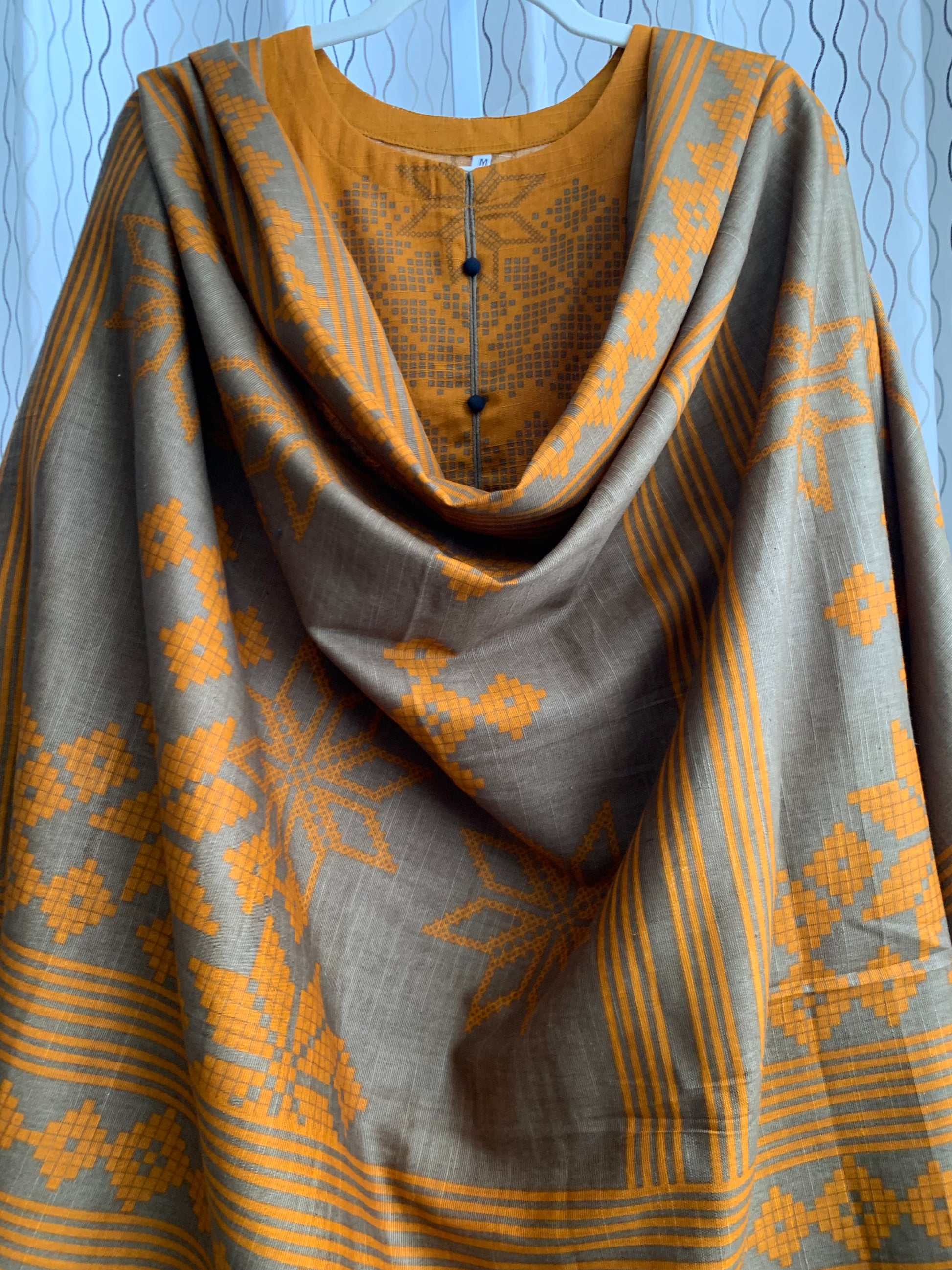 Modest Khaddar Suit for Women:  it offers a Modest Relax Fit Style along with Custom Stitch. Crafted with Exotic Khaddar Fabric, which is a blend of Organic Cotton and Wool Slub. This 3 piece suit includes one Tunic, matching Trouser and a full Shawl, perfect for the winter season. Available in Bronze & Green color, S-M-L-XL  sizes, and guarantees both comfort and elegance.