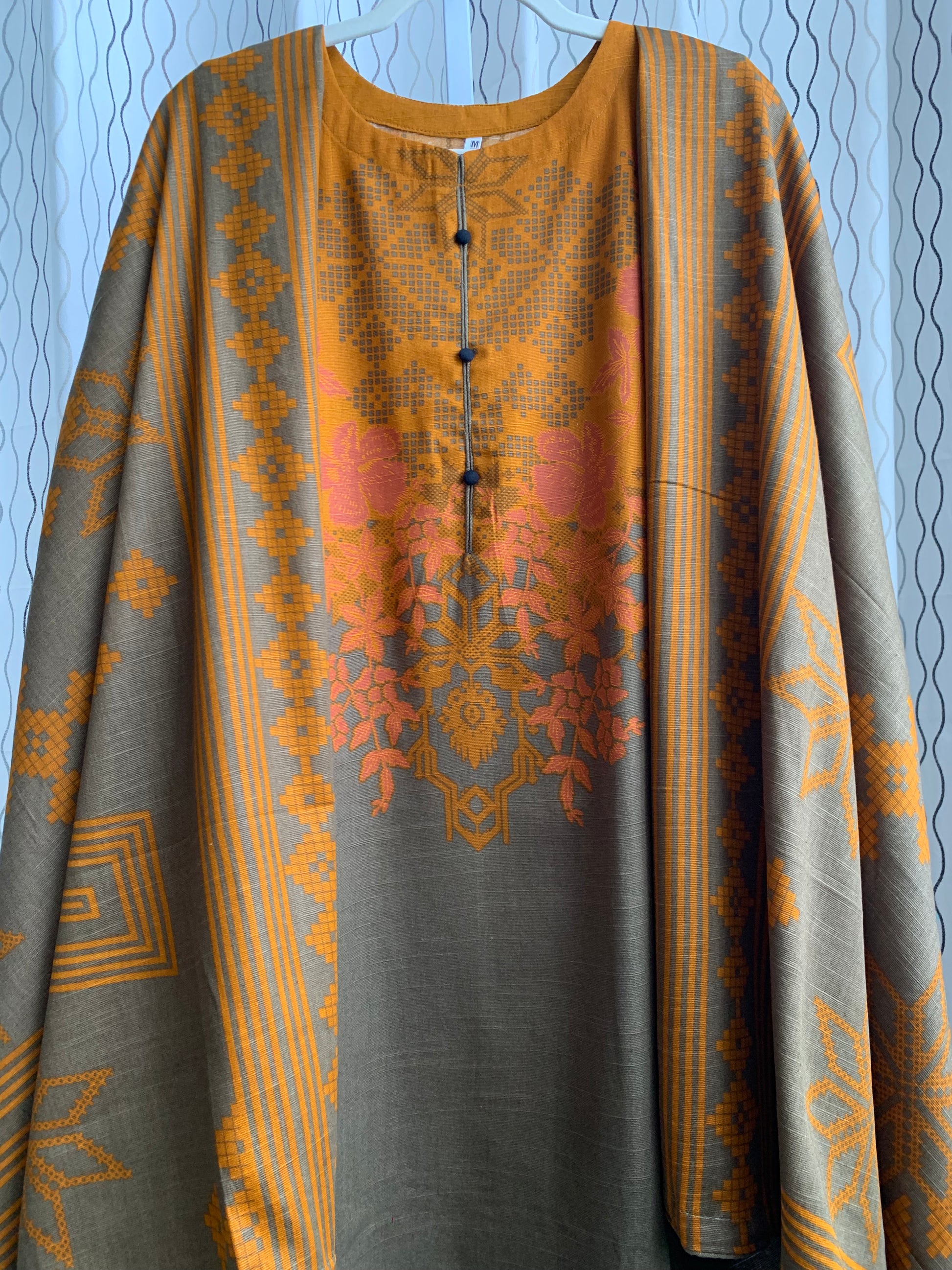 Modest Khaddar Suit for Women:  it offers a Modest Relax Fit Style along with Custom Stitch. Crafted with Exotic Khaddar Fabric, which is a blend of Organic Cotton and Wool Slub. This 3 piece suit includes one Tunic, matching Trouser and a full Shawl, perfect for the winter season. Available in Bronze & Green color, S-M-L-XL  sizes, and guarantees both comfort and elegance.
