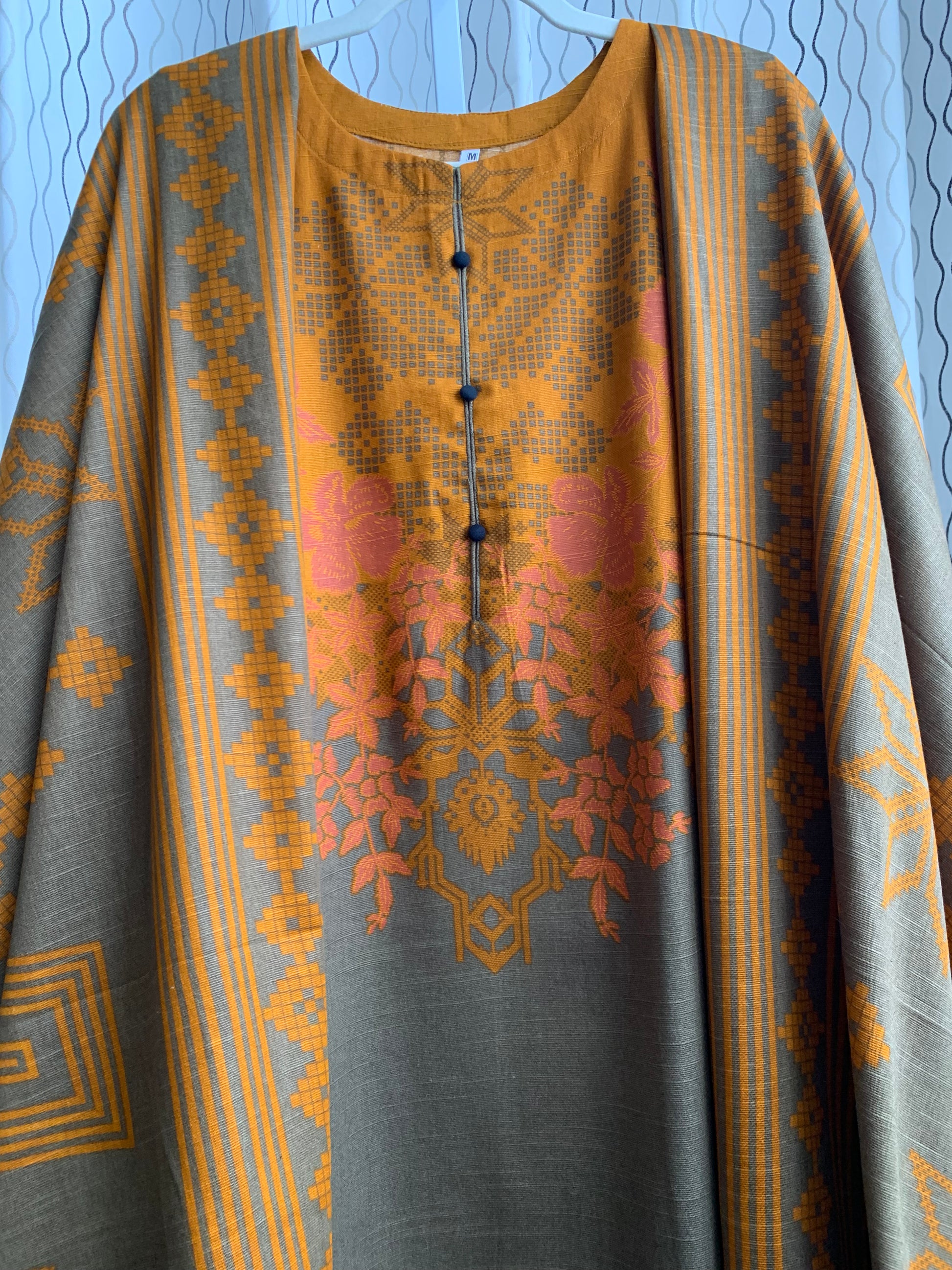 Modest Khaddar Suit for Women:  it offers a Modest Relax Fit Style along with Custom Stitch. Crafted with Exotic Khaddar Fabric, which is a blend of Organic Cotton and Wool Slub. This 3 piece suit includes one Tunic, matching Trouser and a full Shawl, perfect for the winter season. Available in Bronze & Green color, S-M-L-XL  sizes, and guarantees both comfort and elegance.