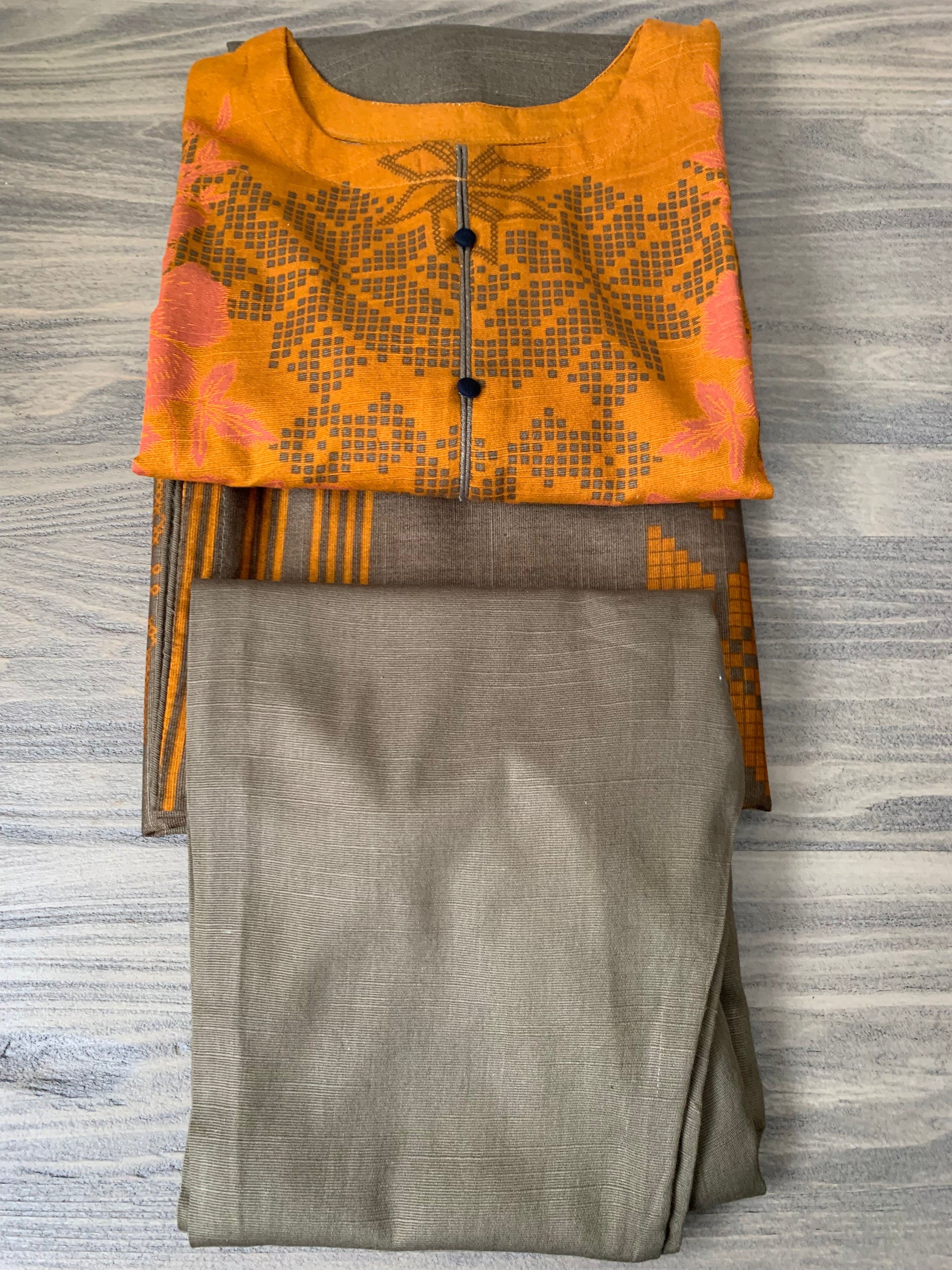 Modest Khaddar Suit for Women:  it offers a Modest Relax Fit Style along with Custom Stitch. Crafted with Exotic Khaddar Fabric, which is a blend of Organic Cotton and Wool Slub. This 3 piece suit includes one Tunic, matching Trouser and a full Shawl, perfect for the winter season. Available in Bronze & Green color, S-M-L-XL  sizes, and guarantees both comfort and elegance.