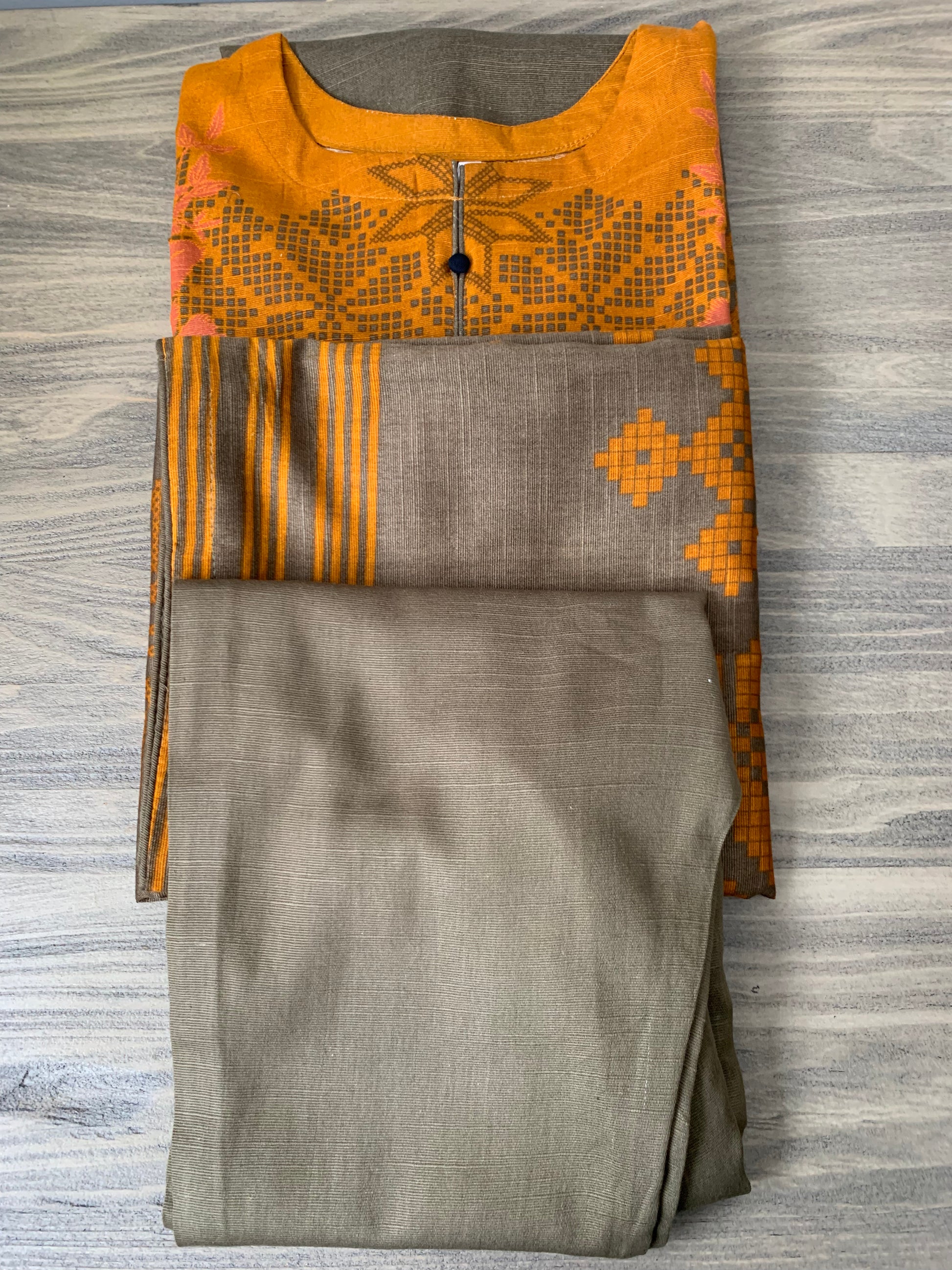 Modest Khaddar Suit for Women:  it offers a Modest Relax Fit Style along with Custom Stitch. Crafted with Exotic Khaddar Fabric, which is a blend of Organic Cotton and Wool Slub. This 3 piece suit includes one Tunic, matching Trouser and a full Shawl, perfect for the winter season. Available in Bronze & Green color, S-M-L-XL  sizes, and guarantees both comfort and elegance.