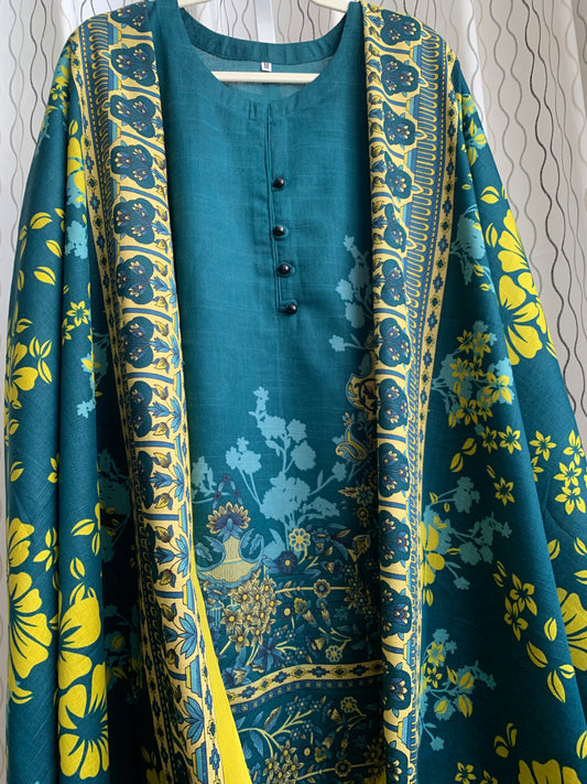 Modest Khaddar Suit for Women:  it offers a Modest Relax Fit Style along with Custom Stitch. Crafted with Exotic Khaddar Fabric, which is a blend of Organic Cotton and Wool Slub. This 3 piece suit includes one Tunic, matching Trouser and a full Shawl, perfect for the winter season. Available in Dark Green color and S-M-L-XL  sizes, and guarantees both comfort and elegance.