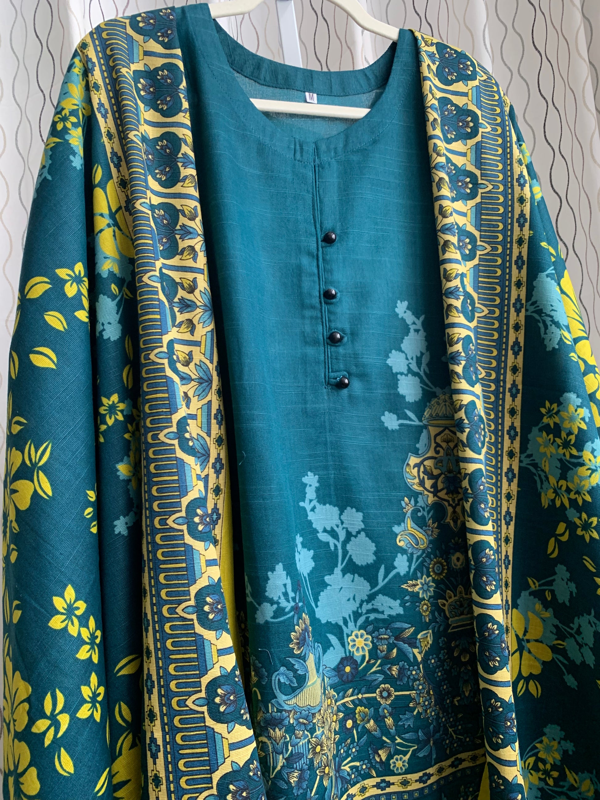 Modest Khaddar Suit for Women:  it offers a Modest Relax Fit Style along with Custom Stitch. Crafted with Exotic Khaddar Fabric, which is a blend of Organic Cotton and Wool Slub. This 3 piece suit includes one Tunic, matching Trouser and a full Shawl, perfect for the winter season. Available in Dark Green color and S-M-L-XL  sizes, and guarantees both comfort and elegance.