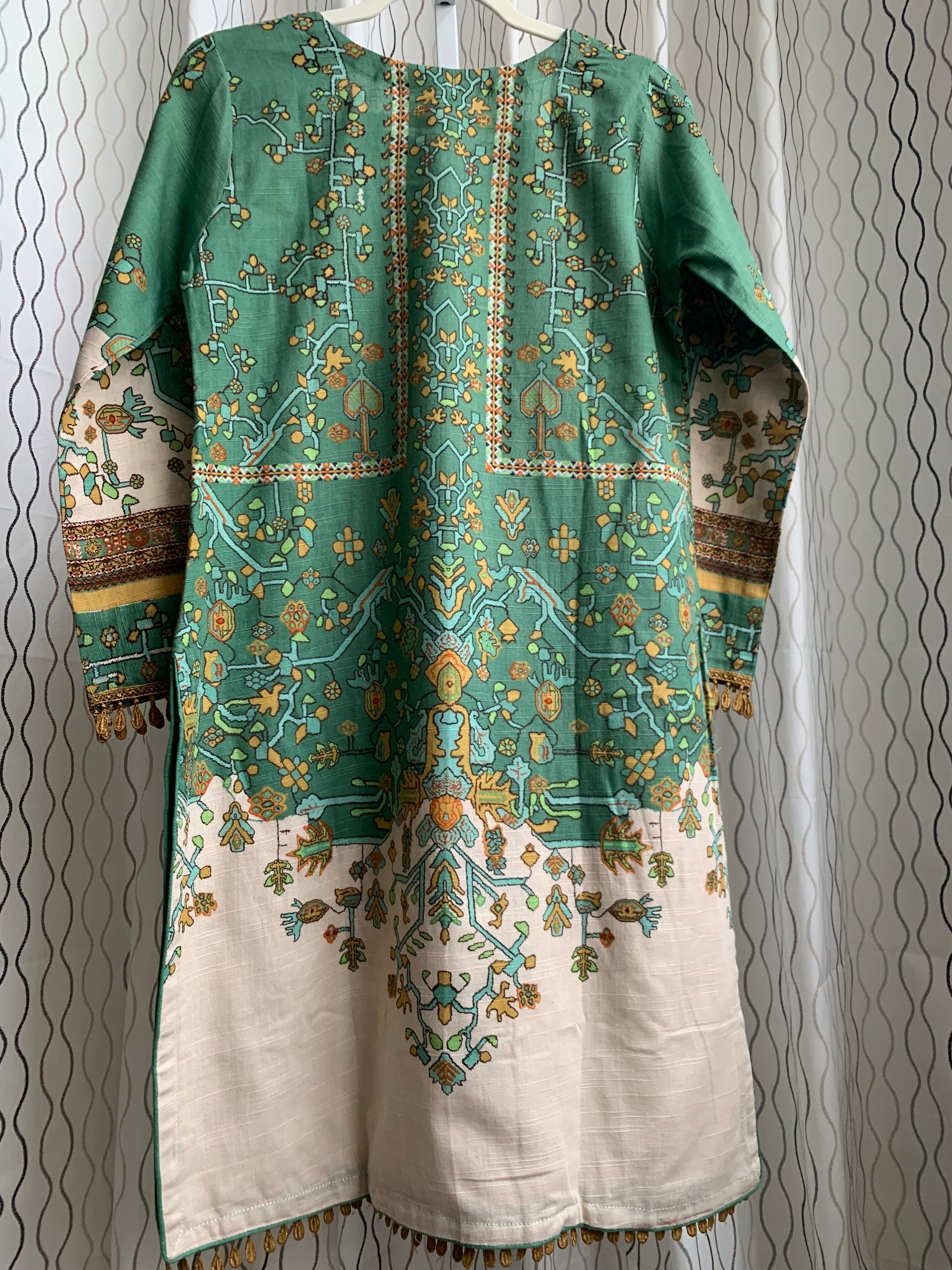 Modest Khaddar Suit for Women: it offers a Modest Relax Fit Style along with Custom Stitch. Crafted with Exotic Khaddar Fabric, which is a blend of Organic Cotton and Wool Slub. This 3 piece suit includes one Tunic, matching Trouser and a full Shawl, perfect for the winter season. Available in Sage Green color with S-M-L-XL sizes, and it guarantees both comfort and elegance.