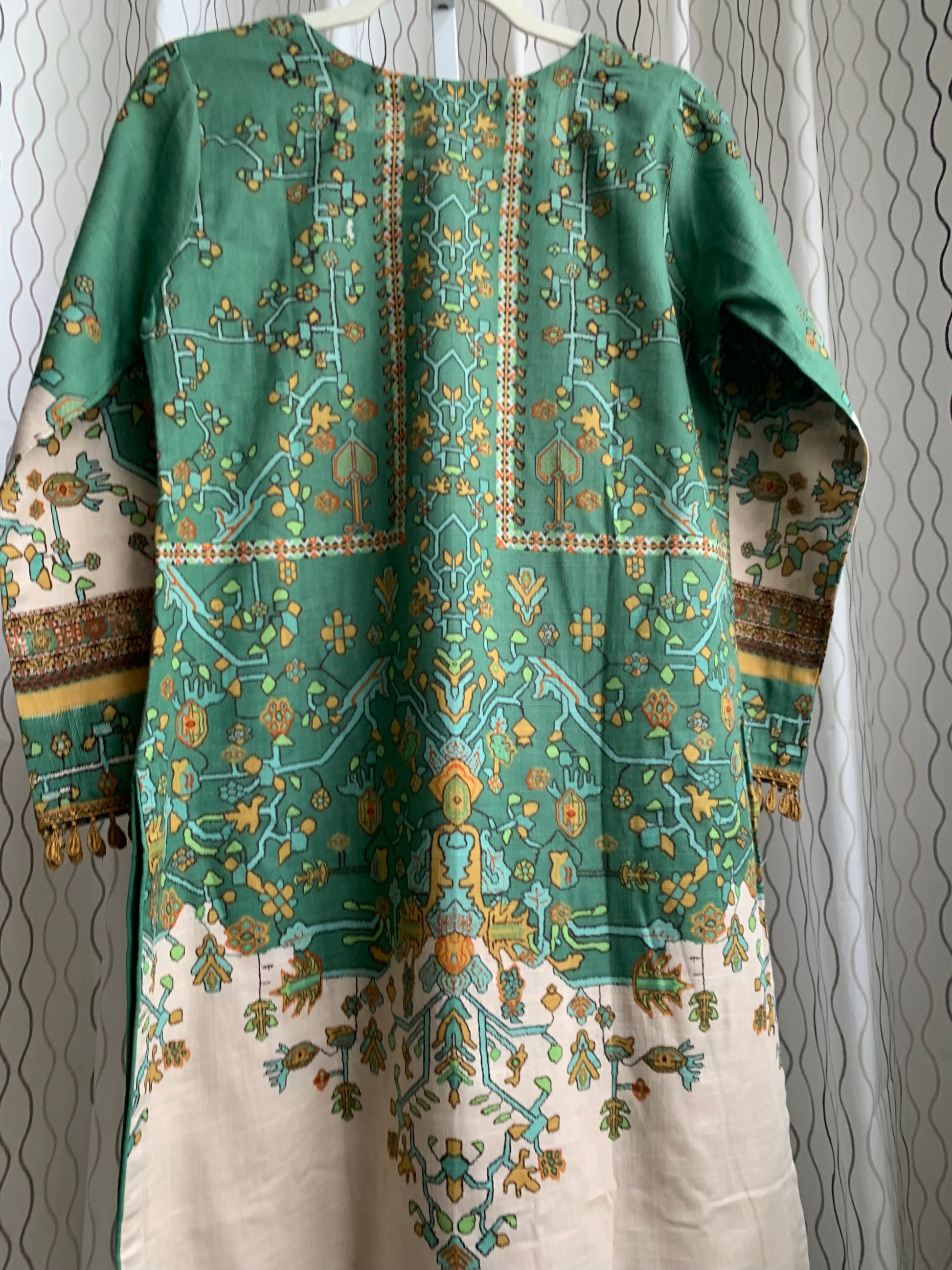 Modest Khaddar Suit for Women: it offers a Modest Relax Fit Style along with Custom Stitch. Crafted with Exotic Khaddar Fabric, which is a blend of Organic Cotton and Wool Slub. This 3 piece suit includes one Tunic, matching Trouser and a full Shawl, perfect for the winter season. Available in Sage Green color with S-M-L-XL sizes, and it guarantees both comfort and elegance.