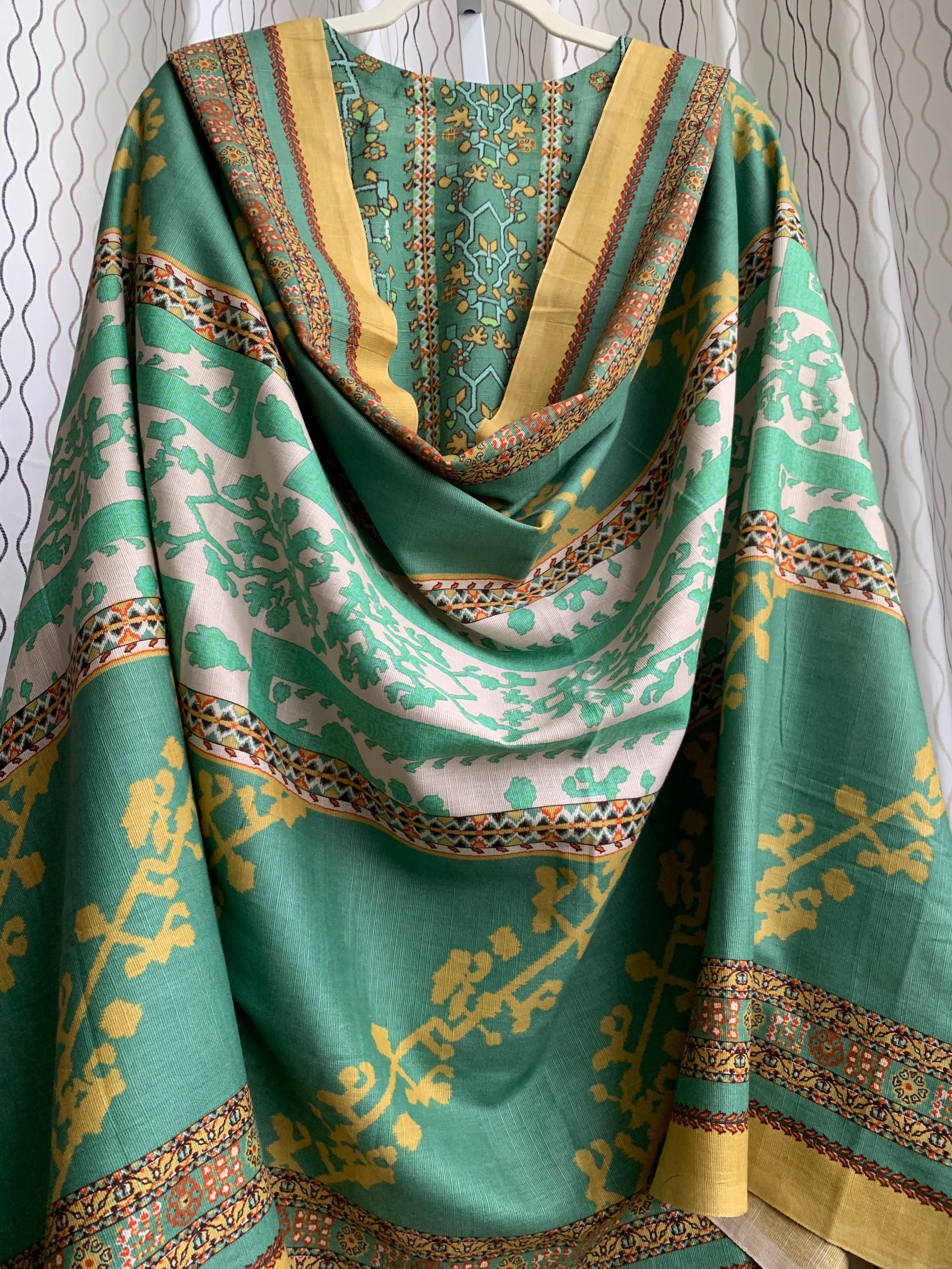 Modest Khaddar Suit for Women: it offers a Modest Relax Fit Style along with Custom Stitch. Crafted with Exotic Khaddar Fabric, which is a blend of Organic Cotton and Wool Slub. This 3 piece suit includes one Tunic, matching Trouser and a full Shawl, perfect for the winter season. Available in Sage Green color with S-M-L-XL sizes, and it guarantees both comfort and elegance.