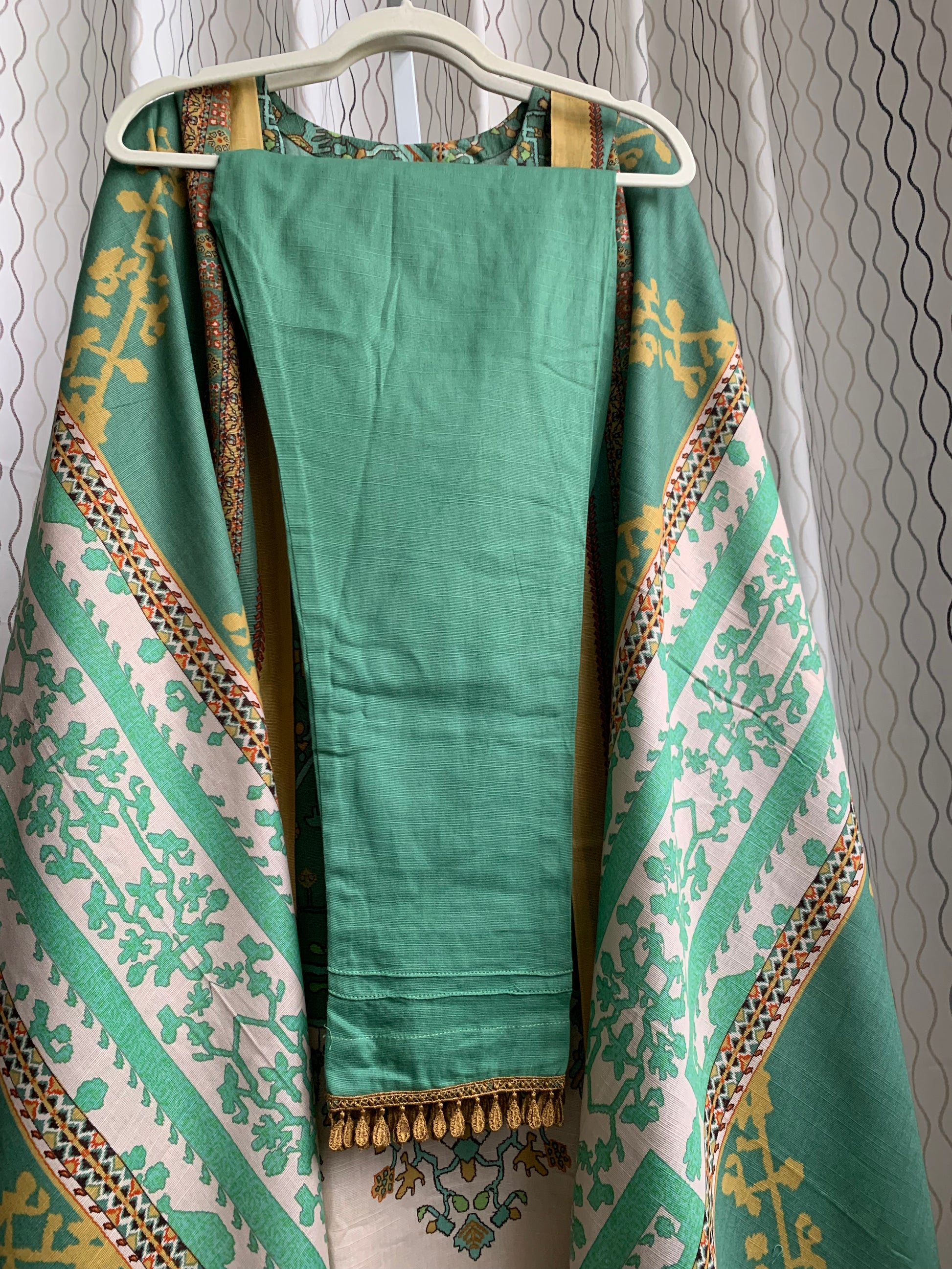 Modest Khaddar Suit for Women: it offers a Modest Relax Fit Style along with Custom Stitch. Crafted with Exotic Khaddar Fabric, which is a blend of Organic Cotton and Wool Slub. This 3 piece suit includes one Tunic, matching Trouser and a full Shawl, perfect for the winter season. Available in Sage Green color with S-M-L-XL sizes, and it guarantees both comfort and elegance.