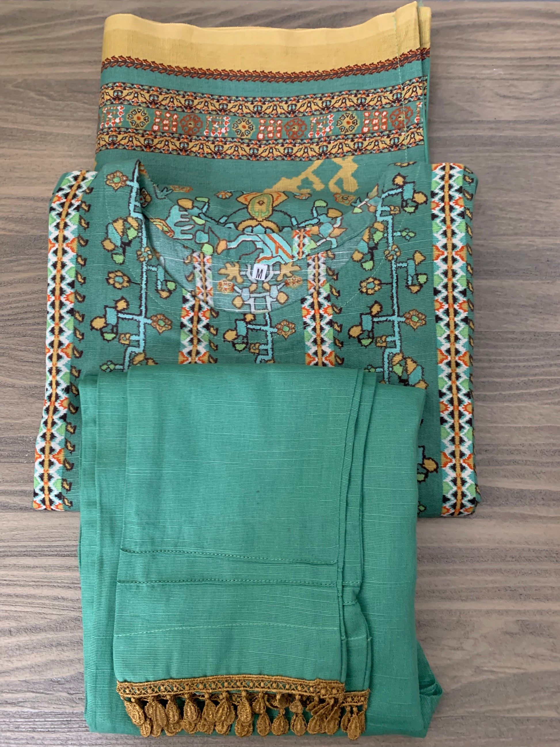 Modest Khaddar Suit for Women: it offers a Modest Relax Fit Style along with Custom Stitch. Crafted with Exotic Khaddar Fabric, which is a blend of Organic Cotton and Wool Slub. This 3 piece suit includes one Tunic, matching Trouser and a full Shawl, perfect for the winter season. Available in Sage Green color with S-M-L-XL sizes, and it guarantees both comfort and elegance.