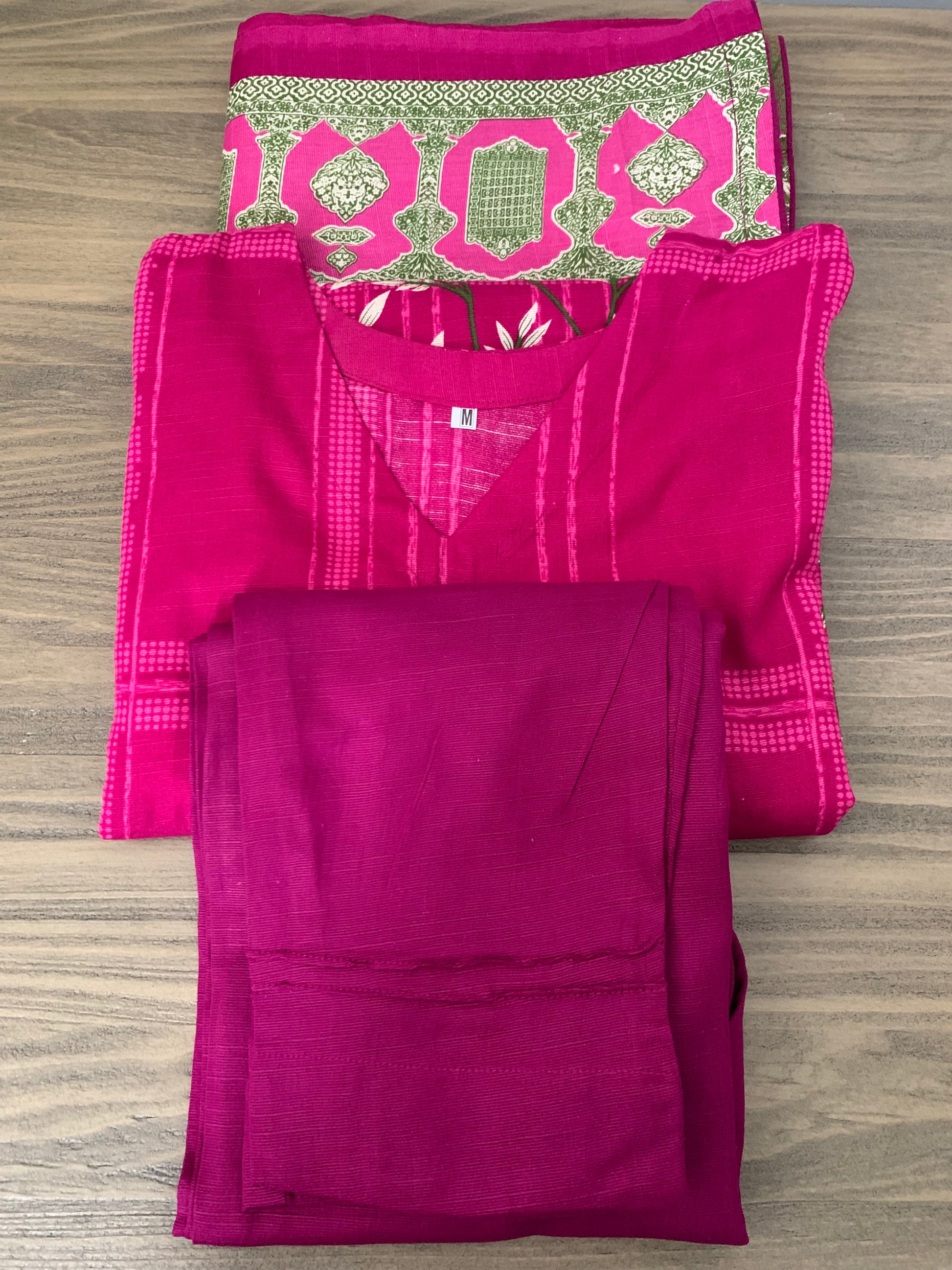 Modest Khaddar Suit for Women: it offers a Modest Relax Fit Style along with Custom Stitch. Crafted with Exotic Khaddar Fabric, which is a blend of Organic Cotton and Wool Slub. This 3 piece suit includes one Tunic, matching Trouser and a full Shawl, perfect for the winter season. Available in Magenta/ HotPink color with S-M-L-XL  sizes, and guarantees both comfort and elegance.