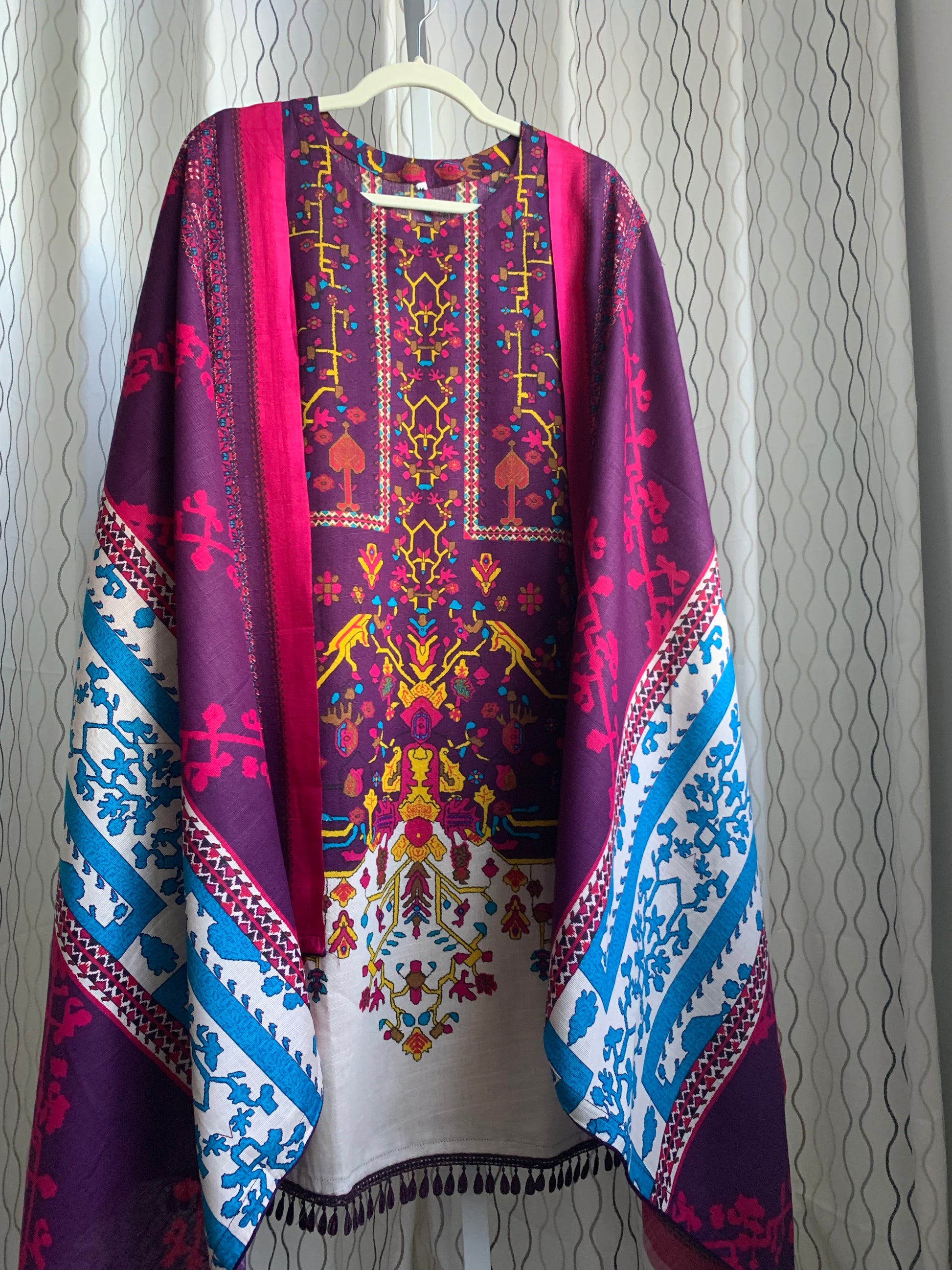 Modest Khaddar Suit for Women:  it offers a Modest Style along with Custom Stitch. Crafted with Exotic Khaddar Fabric, which is a blend of Organic Cotton and Wool Slub. This 3 piece suit includes one Tunic, matching Trouser and a full Shawl, perfect for the winter season. Available in Plum (Dark Purple) color and S-M-L-XL  sizes, and guarantees both comfort and elegance. 