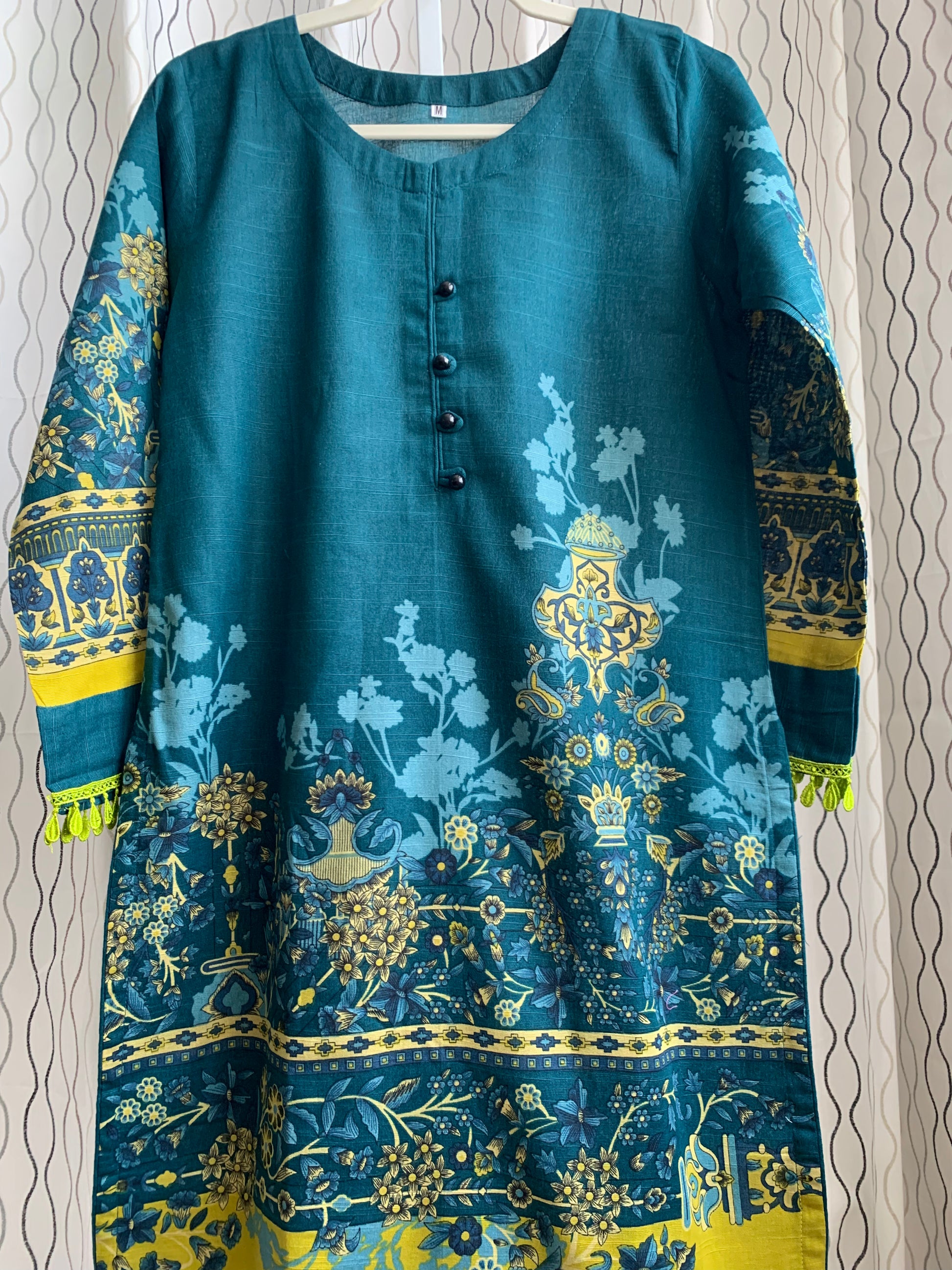 Modest Khaddar Suit for Women:  it offers a Modest Relax Fit Style along with Custom Stitch. Crafted with Exotic Khaddar Fabric, which is a blend of Organic Cotton and Wool Slub. This 3 piece suit includes one Tunic, matching Trouser and a full Shawl, perfect for the winter season. Available in Dark Green color and S-M-L-XL  sizes, and guarantees both comfort and elegance.