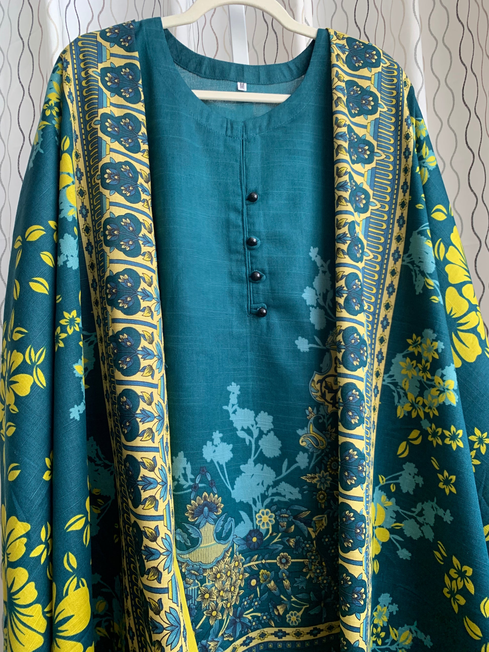 Modest Khaddar Suit for Women:  it offers a Modest Relax Fit Style along with Custom Stitch. Crafted with Exotic Khaddar Fabric, which is a blend of Organic Cotton and Wool Slub. This 3 piece suit includes one Tunic, matching Trouser and a full Shawl, perfect for the winter season. Available in Dark Green color and S-M-L-XL  sizes, and guarantees both comfort and elegance.