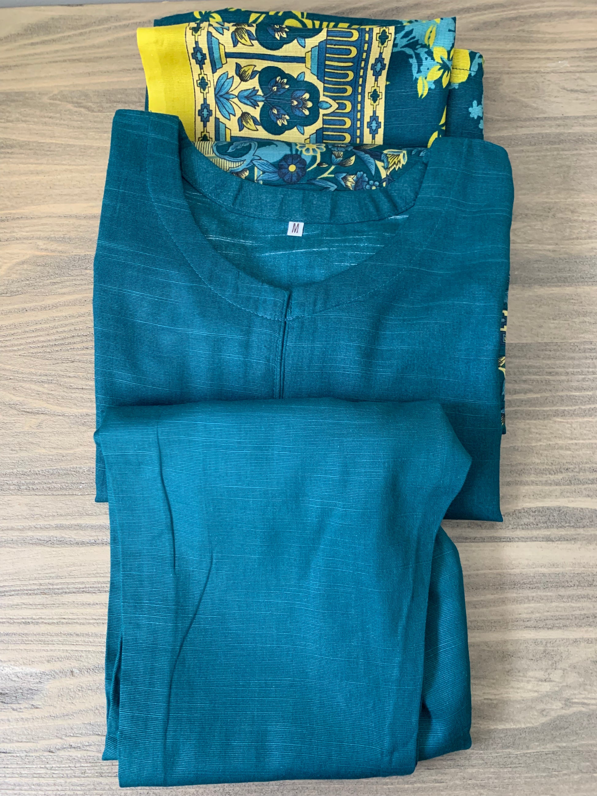 Modest Khaddar Suit for Women:  it offers a Modest Relax Fit Style along with Custom Stitch. Crafted with Exotic Khaddar Fabric, which is a blend of Organic Cotton and Wool Slub. This 3 piece suit includes one Tunic, matching Trouser and a full Shawl, perfect for the winter season. Available in Dark Green color and S-M-L-XL  sizes, and guarantees both comfort and elegance.